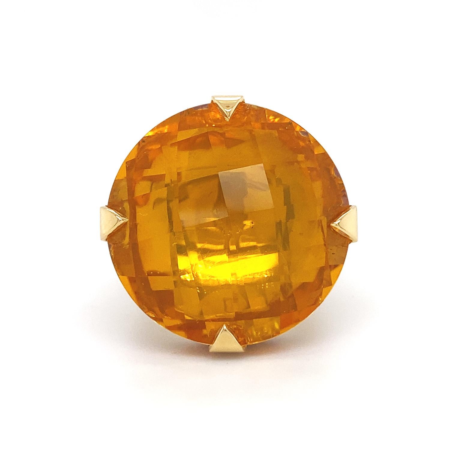 A complimentary trio of colors unifies. Beginning with the burning orange of citrine, it is the culmination of this ring. A checkerboard cut provides more luster. 18k yellow gold prongs secure the citrine. Circling below is a pavé set crown of