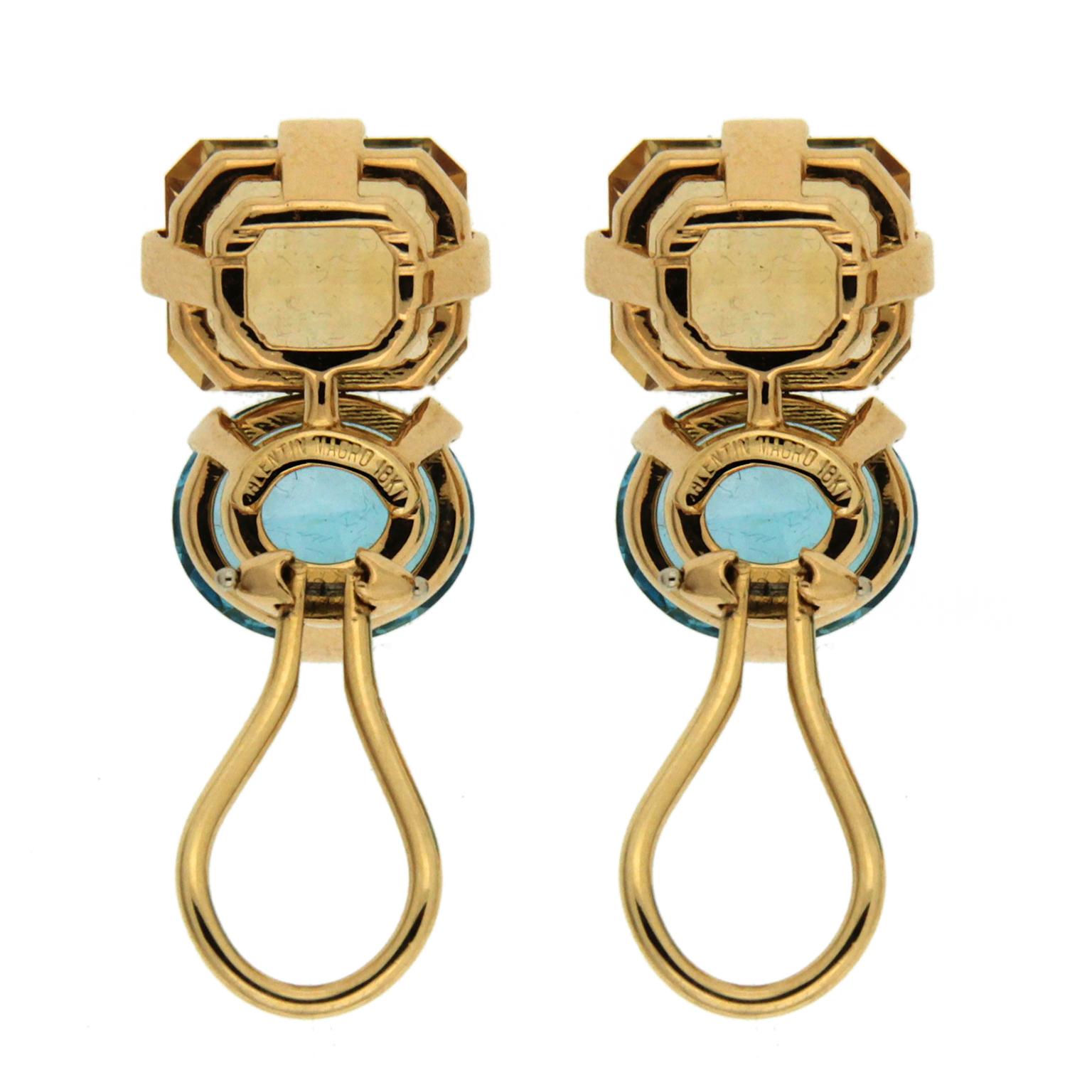 A shock of blue energizes these gold earrings created by Valentin Magro. The body is 18k yellow gold, an emerald cut citrine matching the metal’s hue fills the design’s upper half. Underneath are oval shaped topaz with intense blue. Both gems are