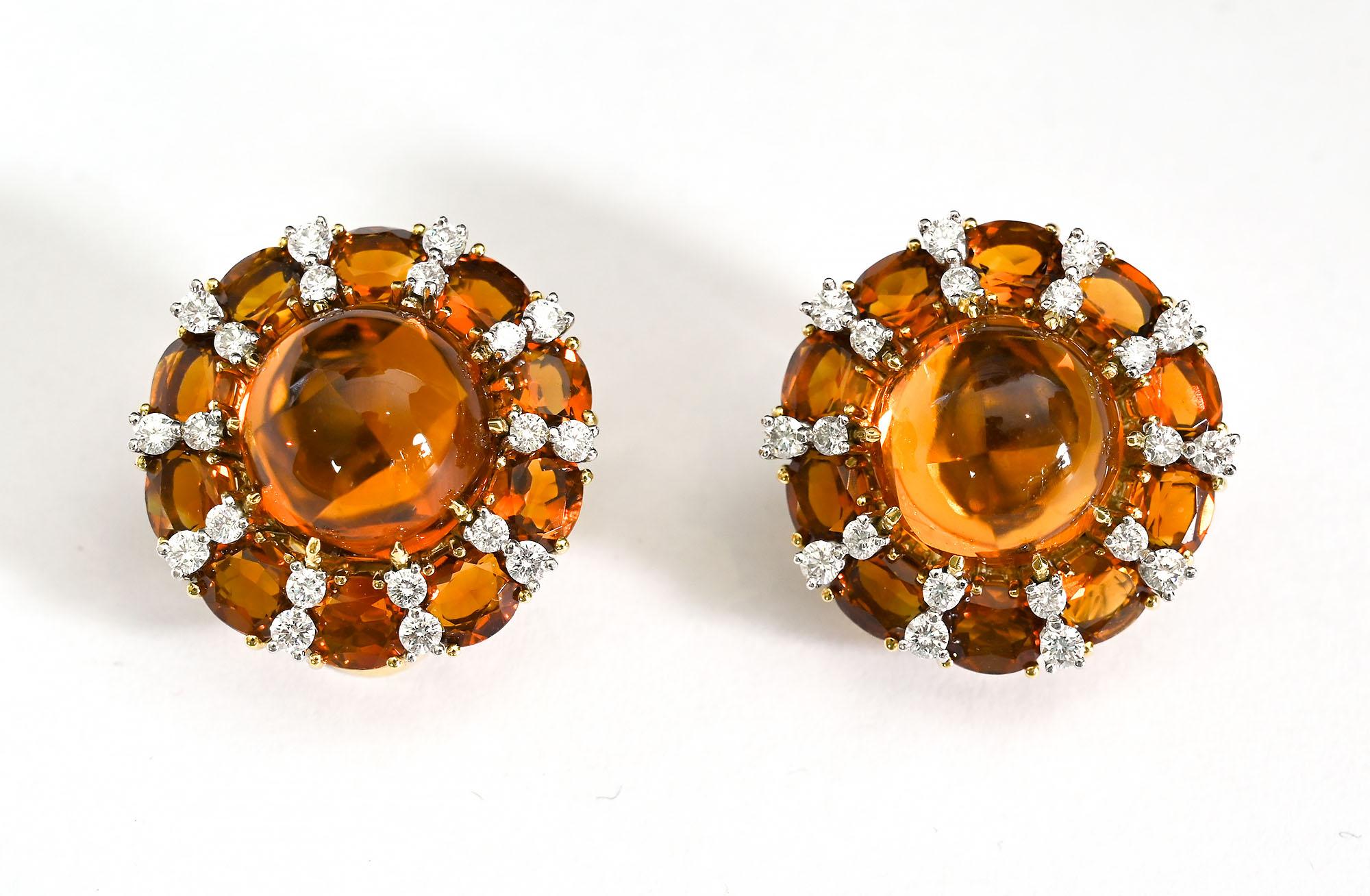 Stunning and elegant citrine and diamond earrings by New York famous jeweler, Valentin Magro. The earrings are centered with a cabochon citrine measuring approximately 13.5 mm in diameter. They are surrounded with spokes of diamonds and citrines.