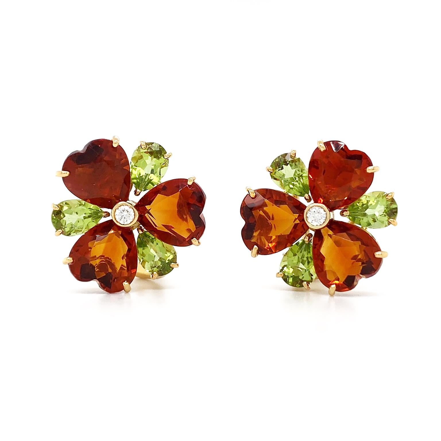 Earth toned jewels create a clover motif. 3 heart shaped citrines meet at their points, each radiating a range of deep orange shades. In between each citrine is a pear shape peridot, emitting bright and olive toned light from its facets. A single