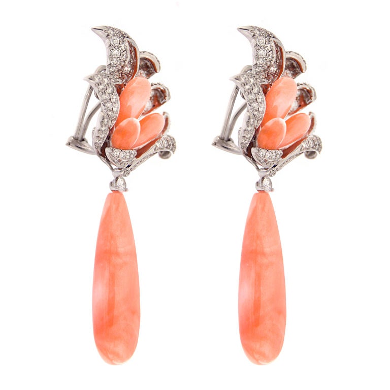 Valentin Magro Coral and Diamond Windblown Flower Drop Earrings are filled with pink and white. Their bases are made of 18k white gold shaped into leaves. Pave set round brilliant cut diamonds enliven the precious metal. Each leaf also serves as a