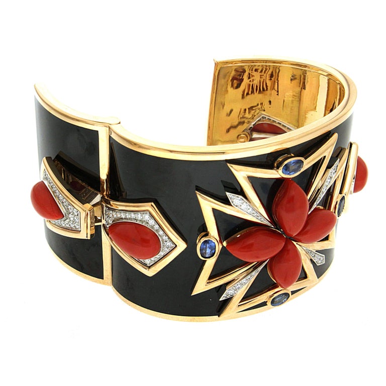 Valentin Magro Coral Black Enamel Sapphires Diamonds Gold Maltese Cuff Bracelet is made of bold lines and color. The body is 18k yellow gold, covered in black enamel. At its center is a Maltese cross outlined in gold. Marquise coral cabochons and