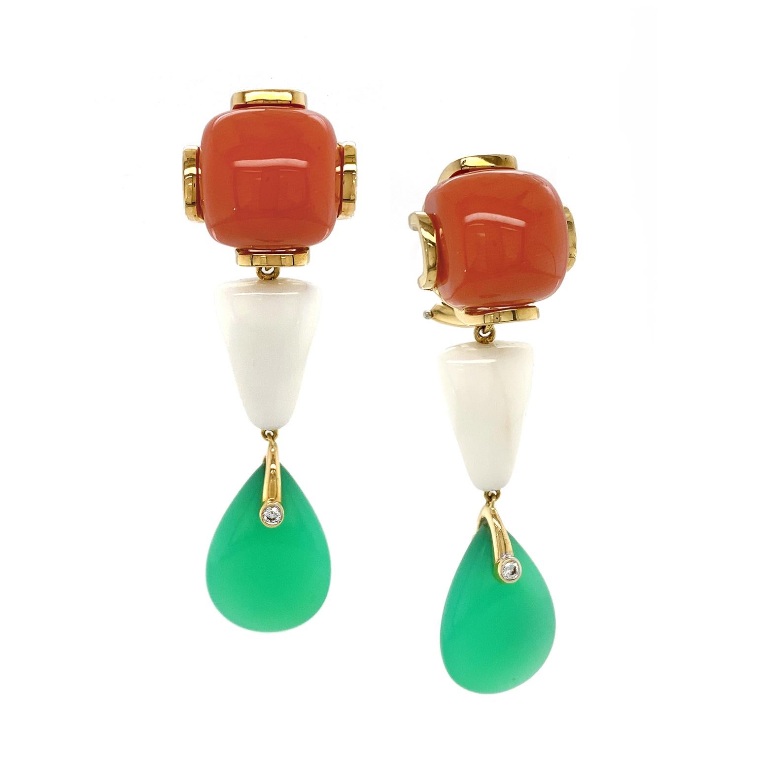 Complementary colors and shapes create a striking effect for these drop earrings. The pattern begins with a cabochon cut of fiery red coral, which is secured by 18k yellow gold bars. Suspending below is a tapered trapezoid cut of white coral,