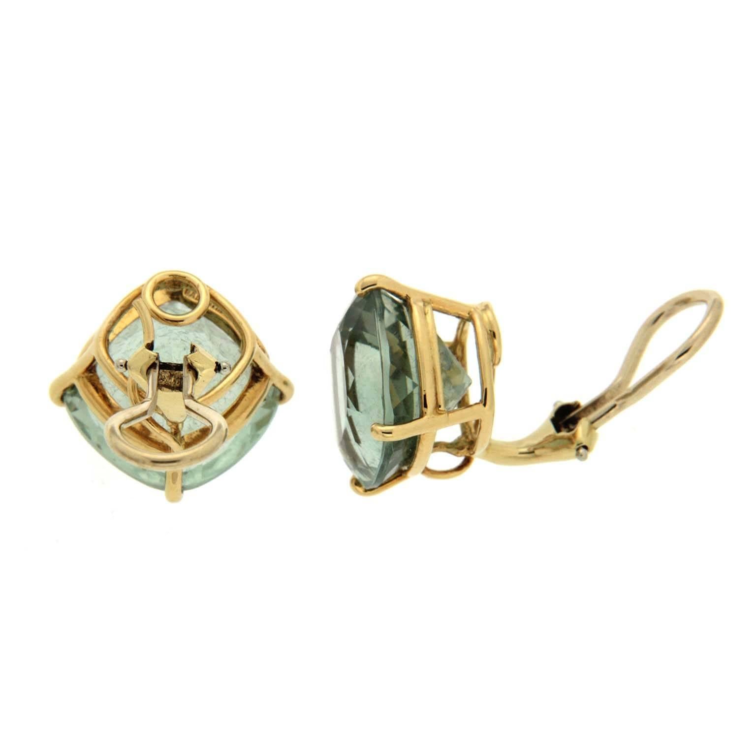 Prasiolite gives these earrings its bluish green hues. The jewels are cushion cut and set on four prongs so they balance on a corner. Both the settings and clip backs are 18k yellow gold. The jewels weigh a combined 25.3 carats.

Measurement detail
