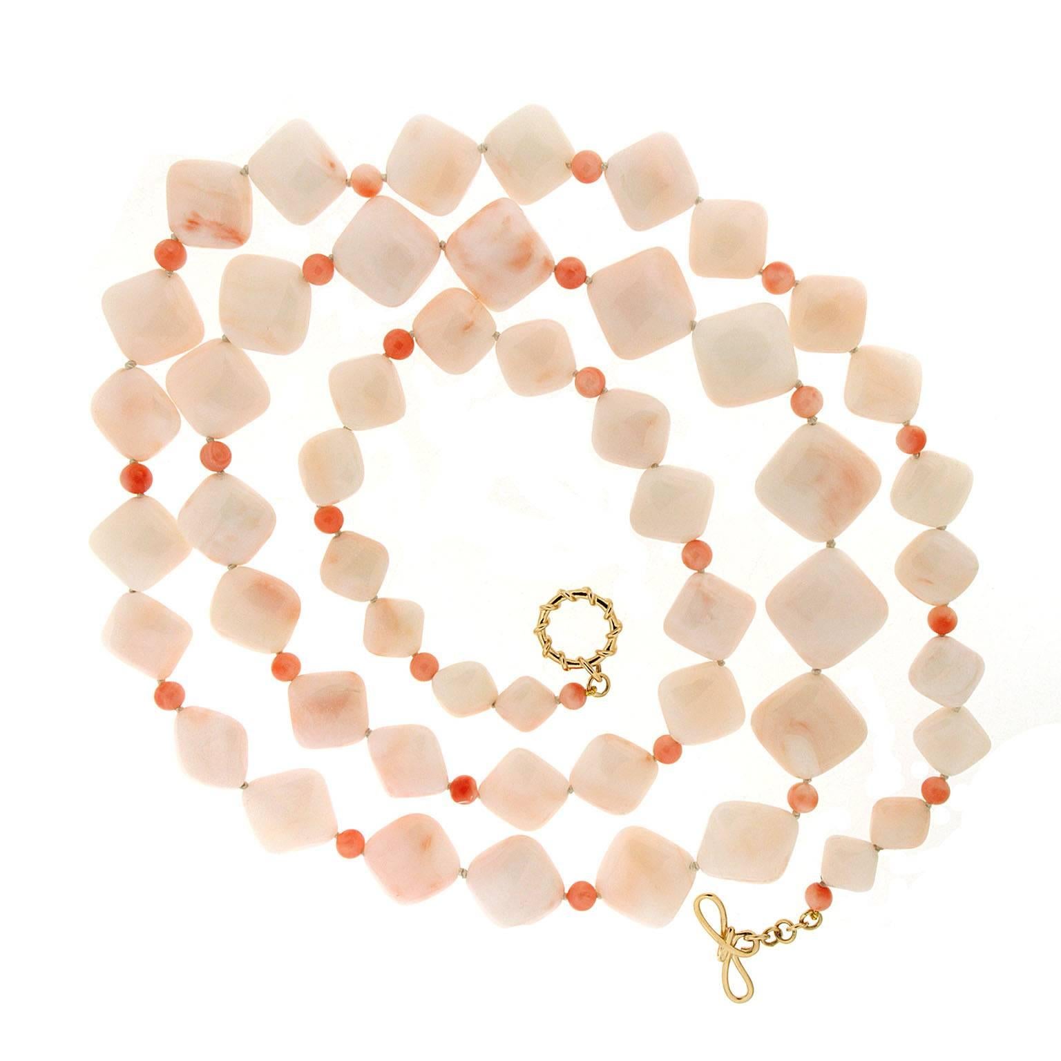 Ivory and blush hues give this necklace an elegant quality. The focus is carved cushion-shaped coral, ranging from soft to faint pink, evoking the cut of chiclets. Strung on their sides as a rhombus, the coral is arranged to graduate smaller towards