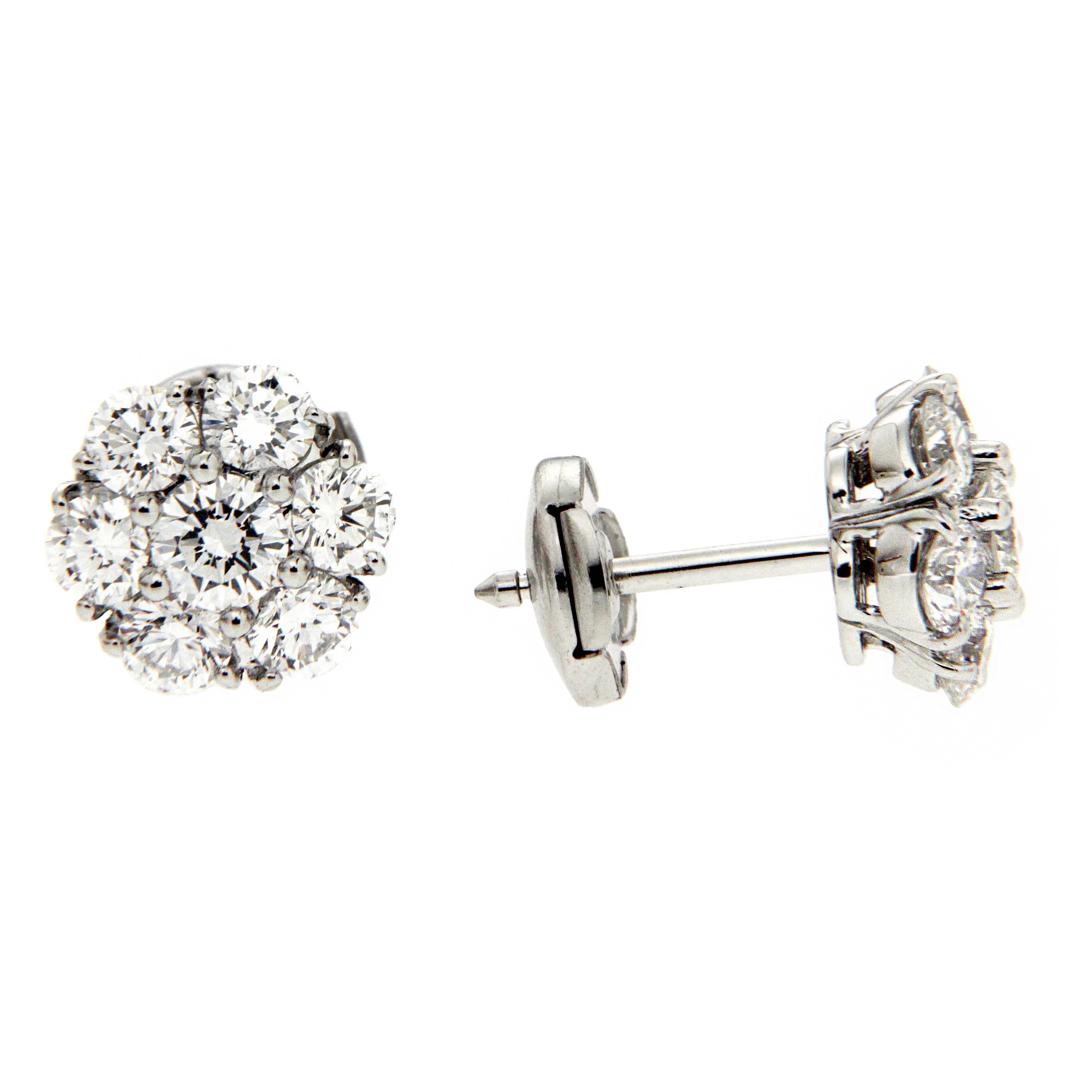 These cluster earrings feature 7 round brilliant diamonds each to form a flower, the diamond carat total weight is 2ct. They are mounted in platinum and are finished with european backs.