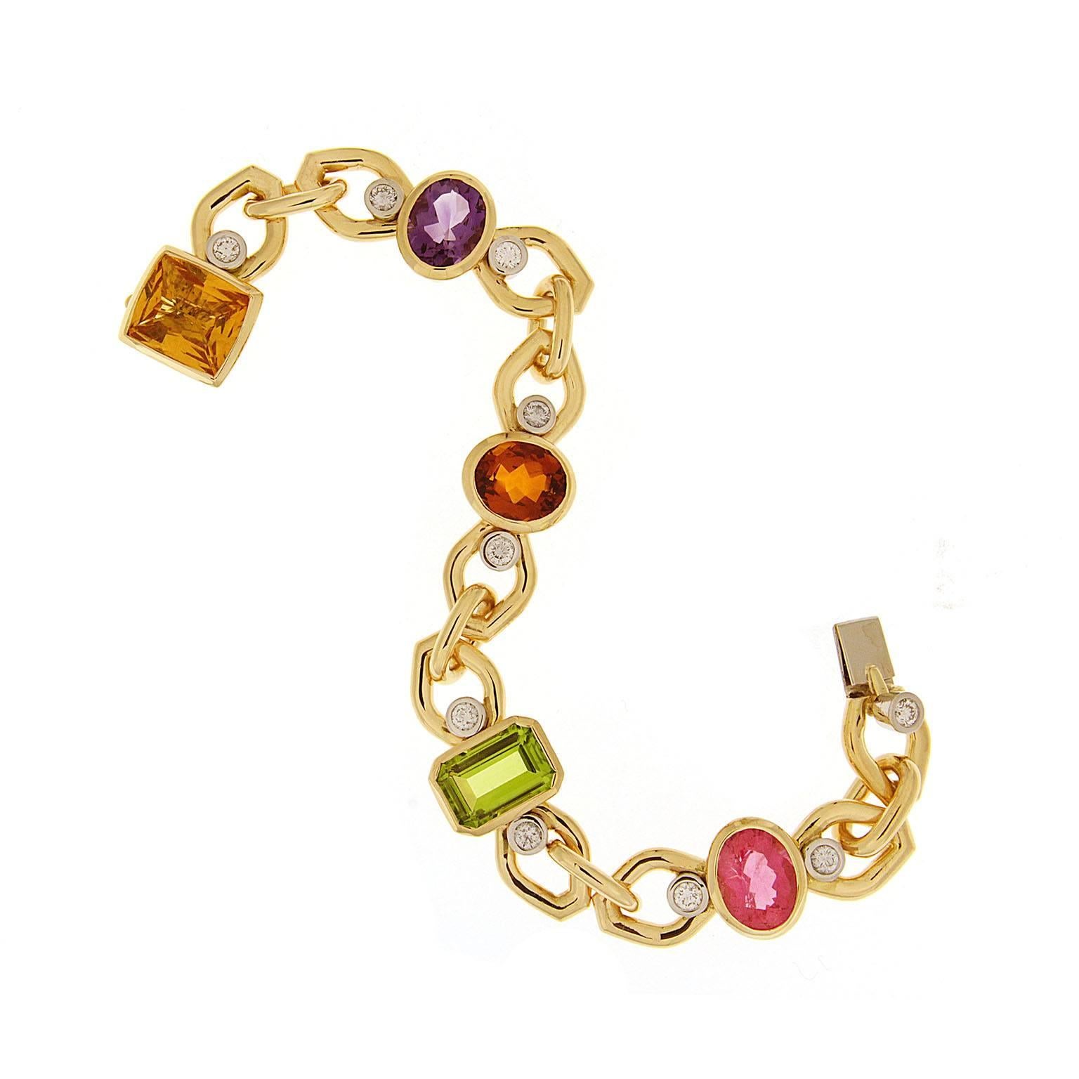 Valentin Magro Diamond Gemstone Link Bracelet boasts a rainbow of jewels. An 18k yellow gold chain makes up the body. Between every three links is a different gem, such as citrine, peridot, pink tourmaline and amethyst. Round brilliant cut diamonds