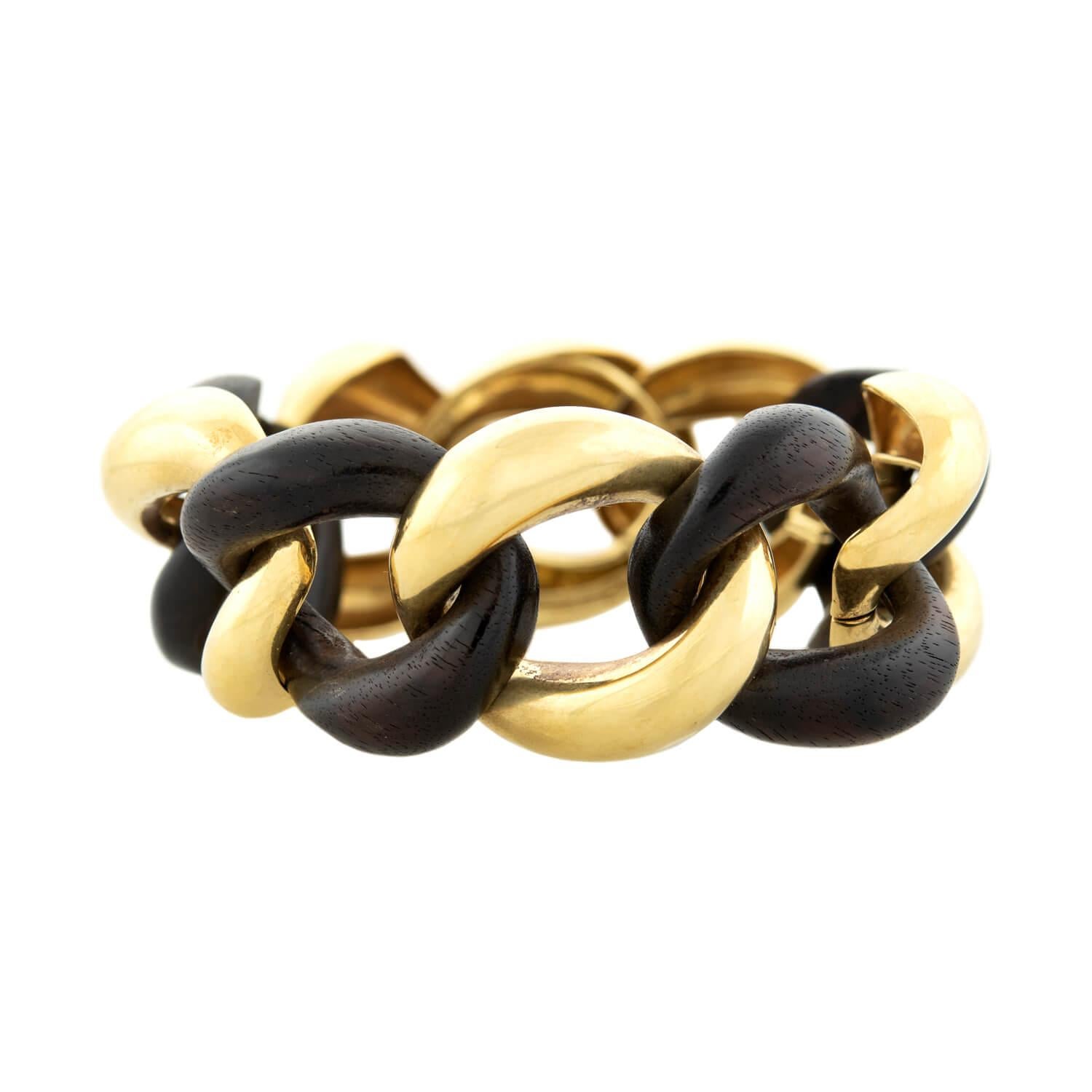 A beautiful estate curb link bracelet from the high end designer Valentin Magro! This substantial piece is comprised of large interlocking curb links, which alternate in material between vibrant 18k and a striking, dark wood. The gold links are