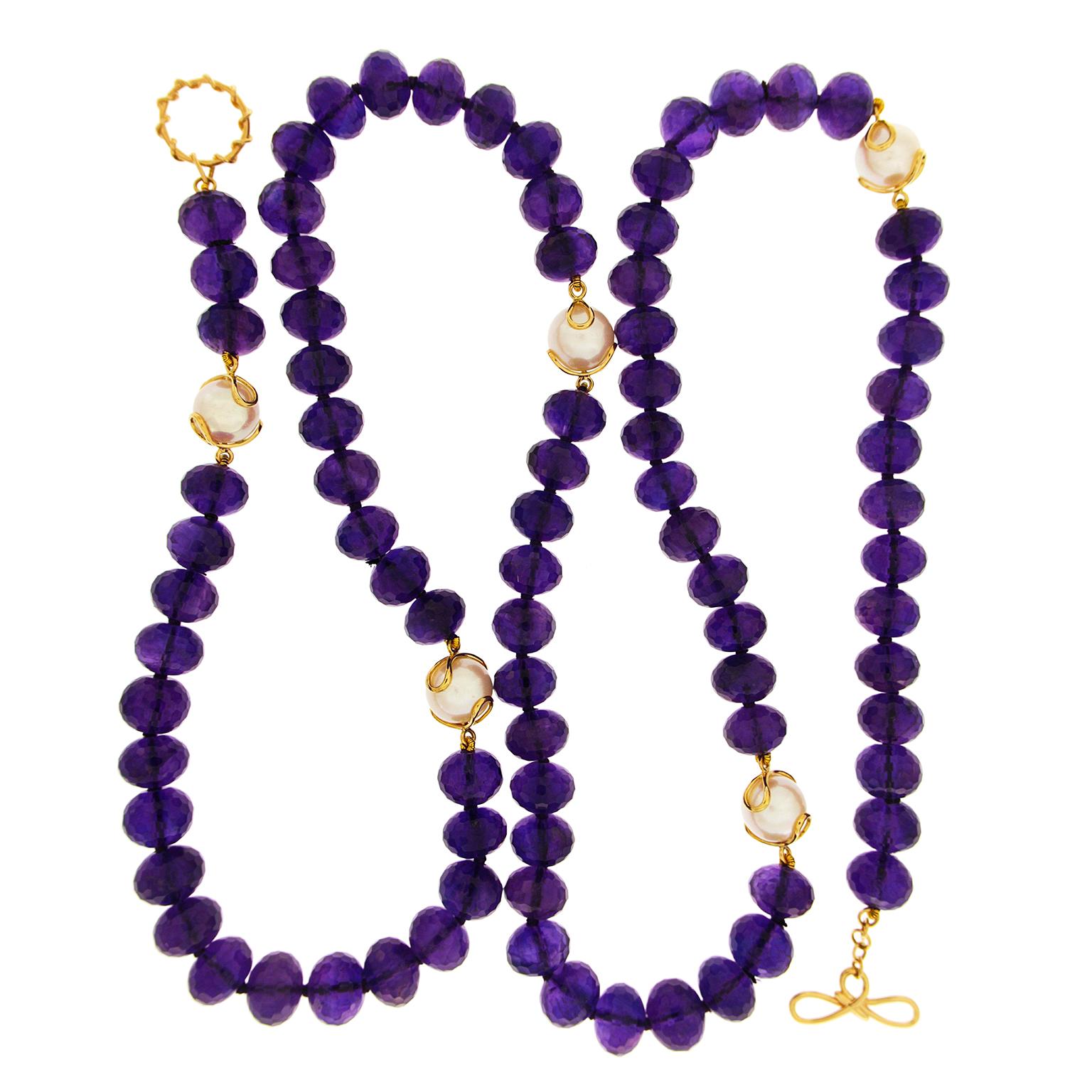 A regal fusion of amethyst and white pearl enlivens this necklace. Rondelles of amethyst release intense violet hues through their facetted semitransparent bodies. Five freshwater pearls are specially placed throughout the necklace for a satin