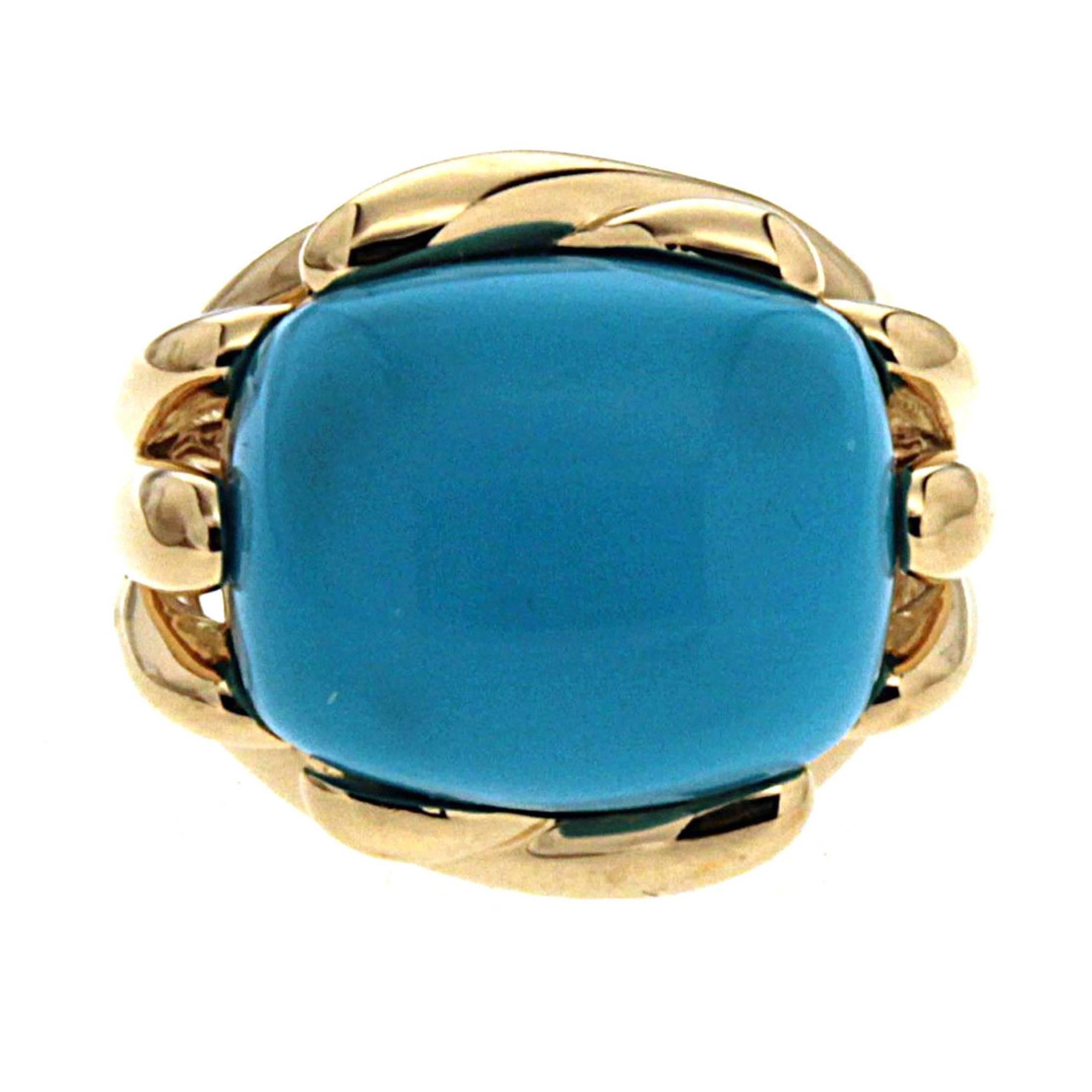 Valentin Magro Fluted Criss Cross Cushion Turquoise Sleeping Beauty Ring exhibits light blues. The turquoise is shaped into an elongated cushion and set sideways in the ring. The 18k yellow gold shank splits as it rises. Some pieces spread apart,