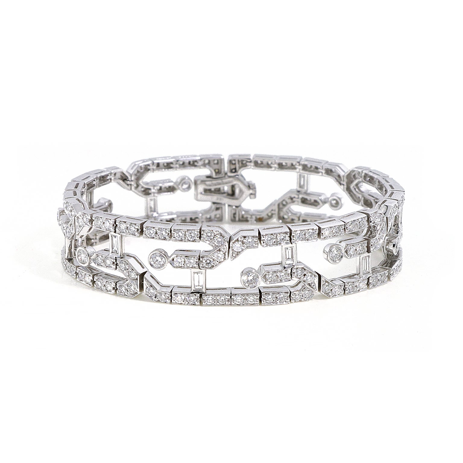 Influenced by the glamour of Art Deco, this bracelet glistens entirely with diamonds. Baguette cut diamonds form two parallel rows with every fifth diamond leading into a gentle curve inward. The result is an openwork pattern of staggered diamonds.