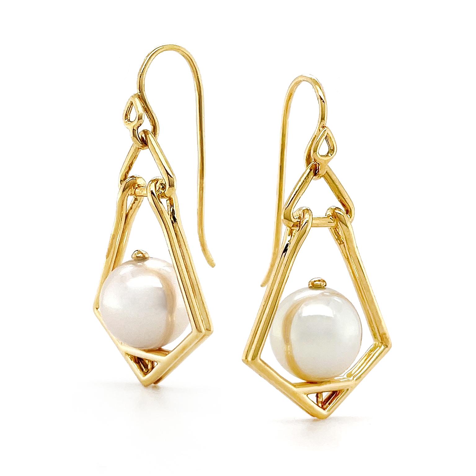 Valentin Magro Geometric Lantern Large Pearl Earrings shine with iridescence rather than fire. Angular shapes flare down from 18k yellow gold French hooks, resembling an old-time lamp. Cultured pearls stand in for flames. Their microscopic structure