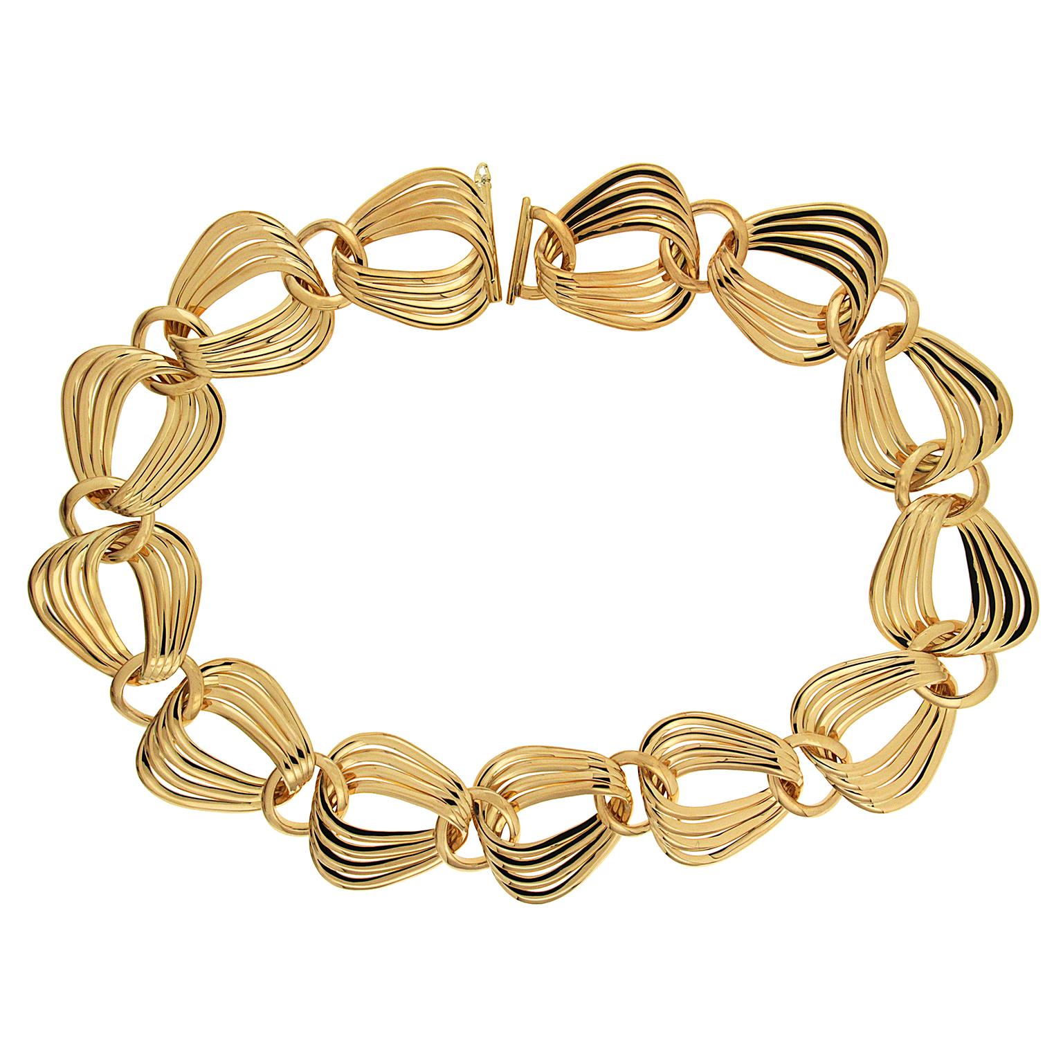 Variety influences this necklace created by Valentin Magro. Lone 18k yellow gold circles sit evenly throughout the design. Pear shaped links rest in loose clusters of four, fanning out to provide a sense of abundance. A simple clasp connects