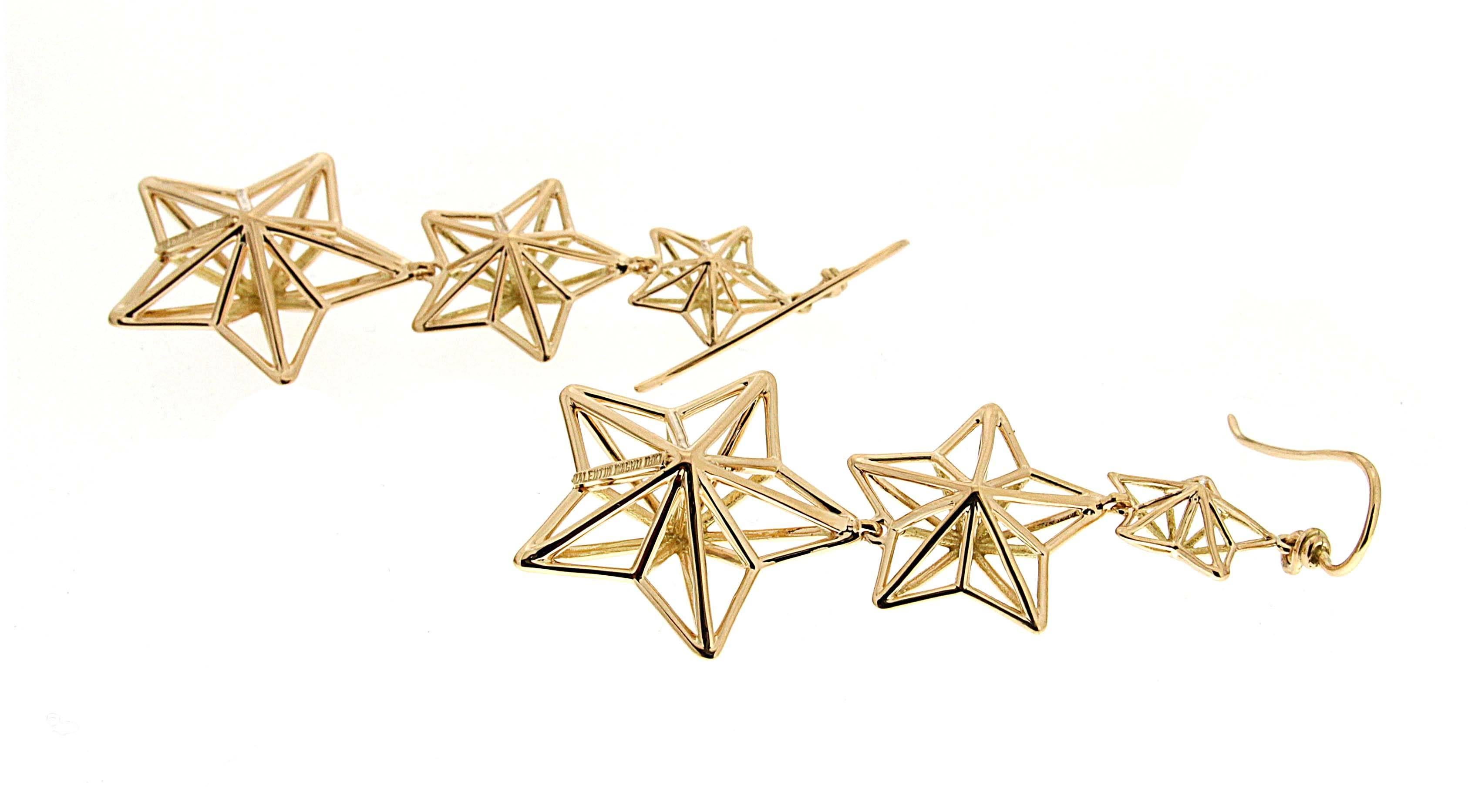 Valentin Magro Gold Star Dangle Earrings with French Wire are stellar. Strips of 18k yellow gold form five-pointed stars. More bars fill their centers, giving the shapes three dimensions. There are three stars to each earring, with the smallest on