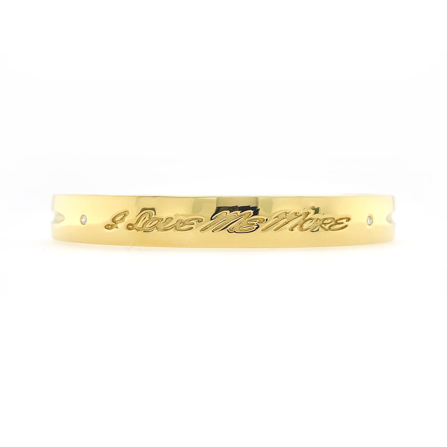 Diamonds highlight this bracelet’s message. The base is an 18k yellow-gold bangle with hinges for ease of wearing. Two round brilliant cut diamonds are burnish set into the bracelet, their tops level with the gold’s surface. The phrase 'I love me