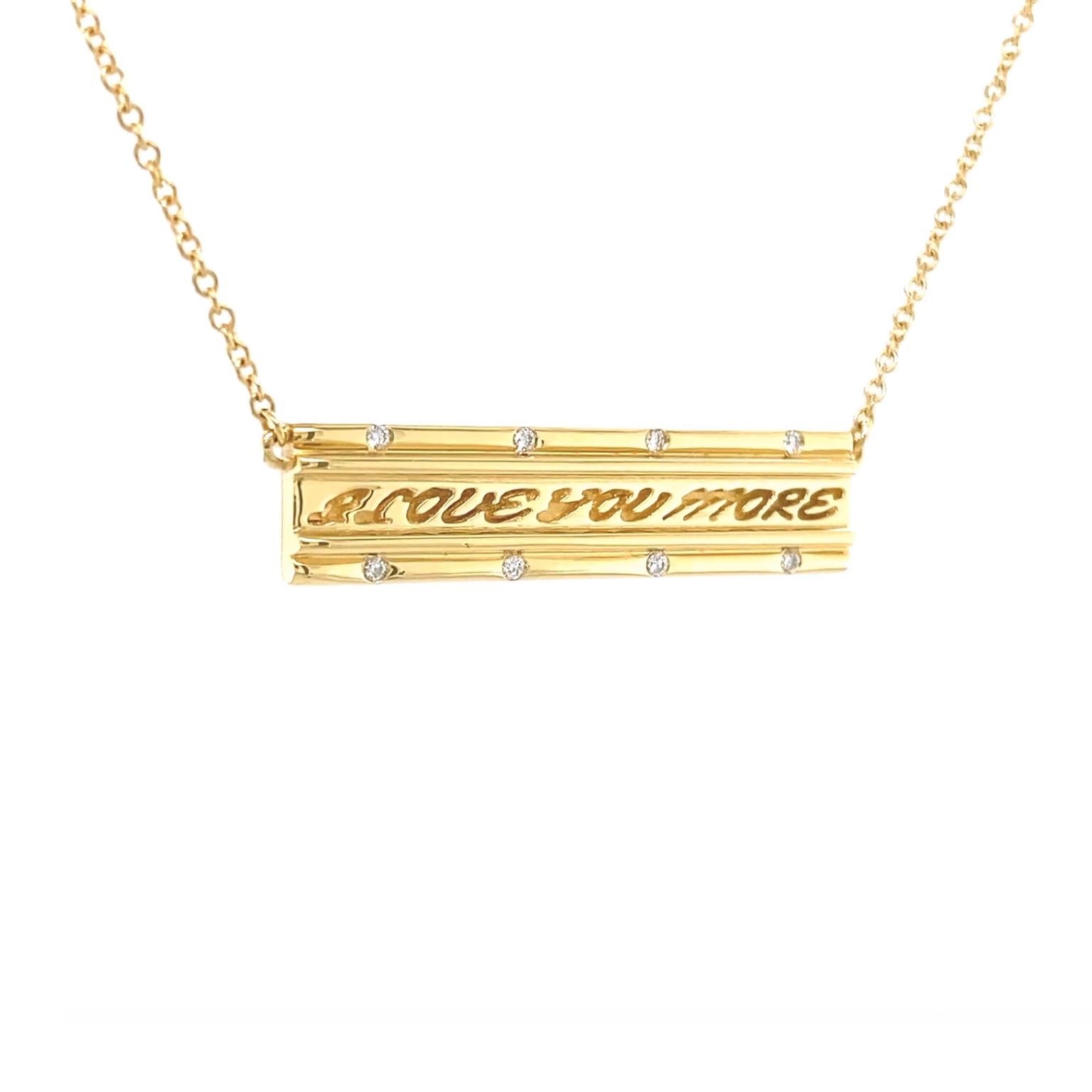 Love and diamonds adorn this pendant. The 18k yellow-gold base is shaped into a bar. In the center are the engraved words 'I love you more.' Smooth wires embedded along the sides frame the message. Flush set round brilliant cut diamonds bring
