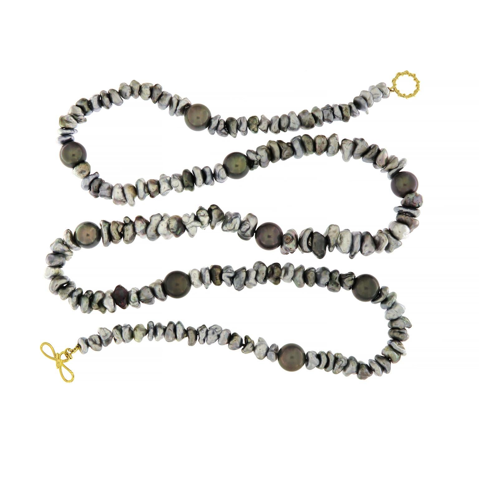 Valentin Magro Keshi and Baroque Tahitian Pearl Necklace plays with shape and hue. The dominant jewel are keshi pearls, pure nacre gems with irregular forms. Round Tahitian pearls dot the length of the strand. When light hits the pearls’ surfaces,