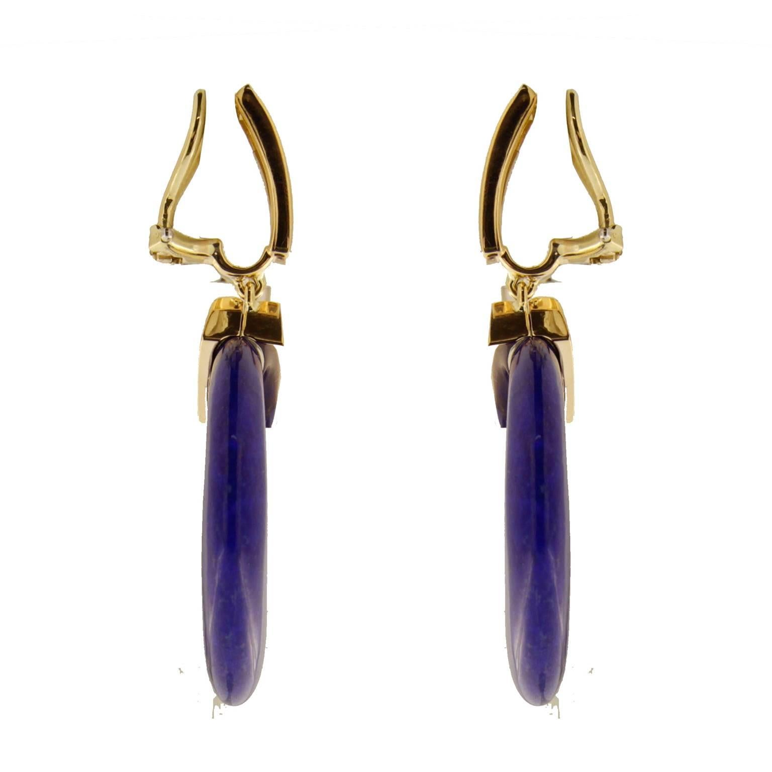 These dangling earrings feature special cut lapis lazuli and 0.61ctw of micro pave set diamonds. They are mounted in 18kt yellow gold and are finished with clip-backs.