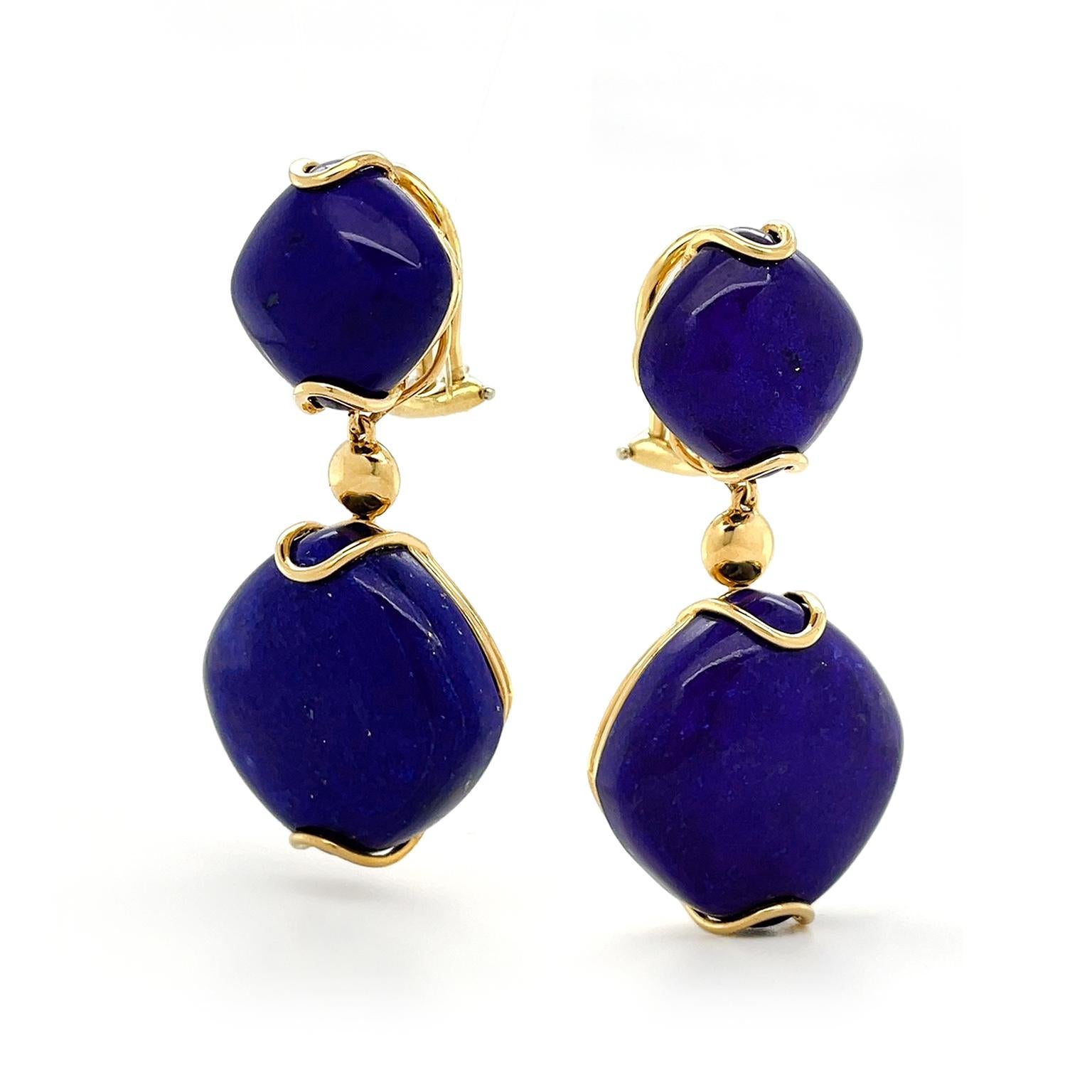 Cobalt-saturated lapis lazuli is the heart of these drop earrings accented by 18k yellow gold. A small carved cushion of the gemstone is turned on its side as a rhombus to begin the design. 18k yellow gold wire loops secure the top and bottom