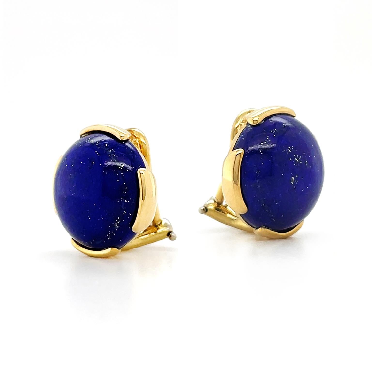 The profuse blue violet of lapis lazuli is presented in round cabochons. 18k yellow gold sets the gem with four round edges visible, which bring out the golden flecks that glitter within the lapis lazuli. The total weight of the gem is 21.28 carats.