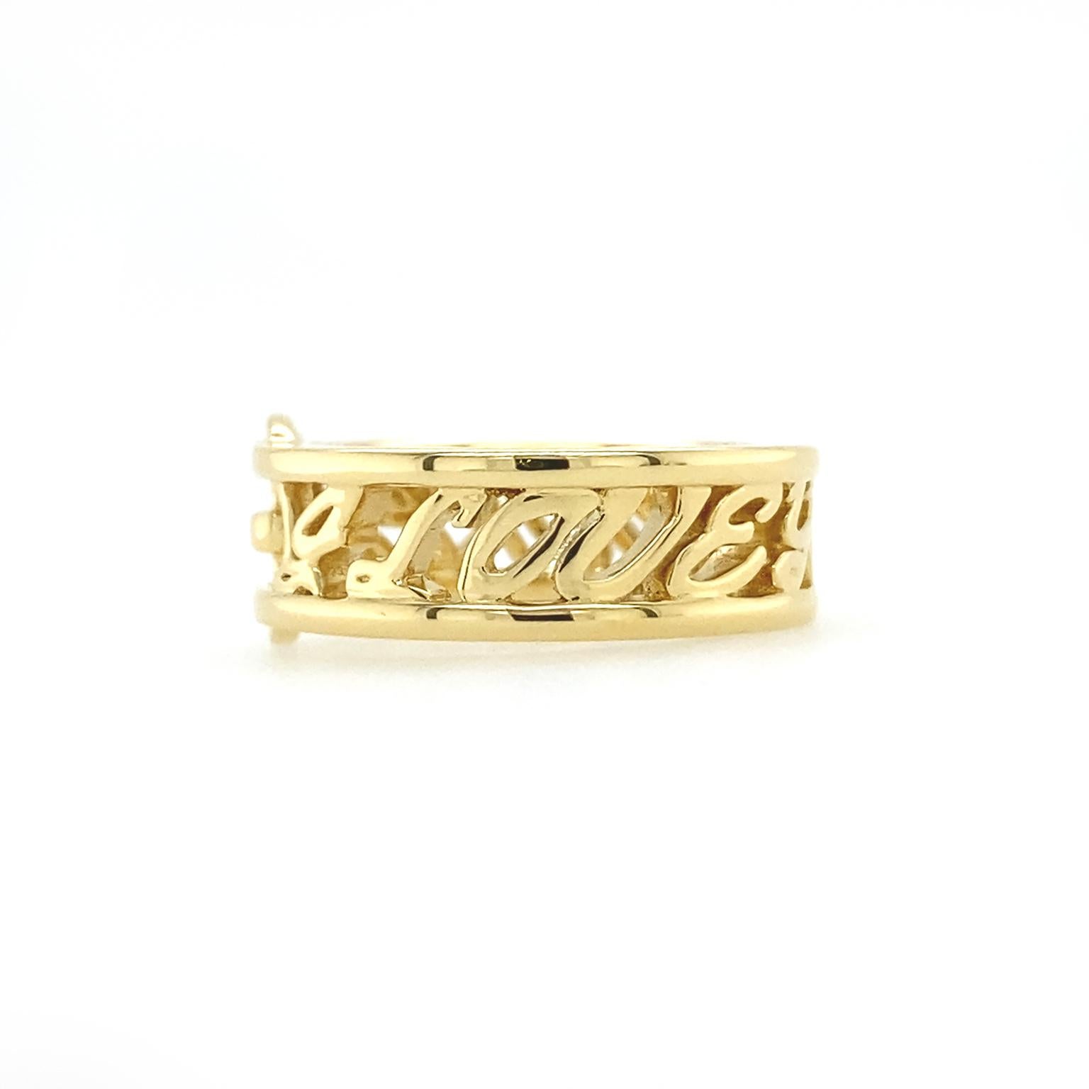 Several touches make this ring stand out. One is a buckle, complete with bar, prong and oval frame. The words 'I love you more' span the rest of the band, with cursive letters traveling between thin shanks. Taken together, the buckle turns the