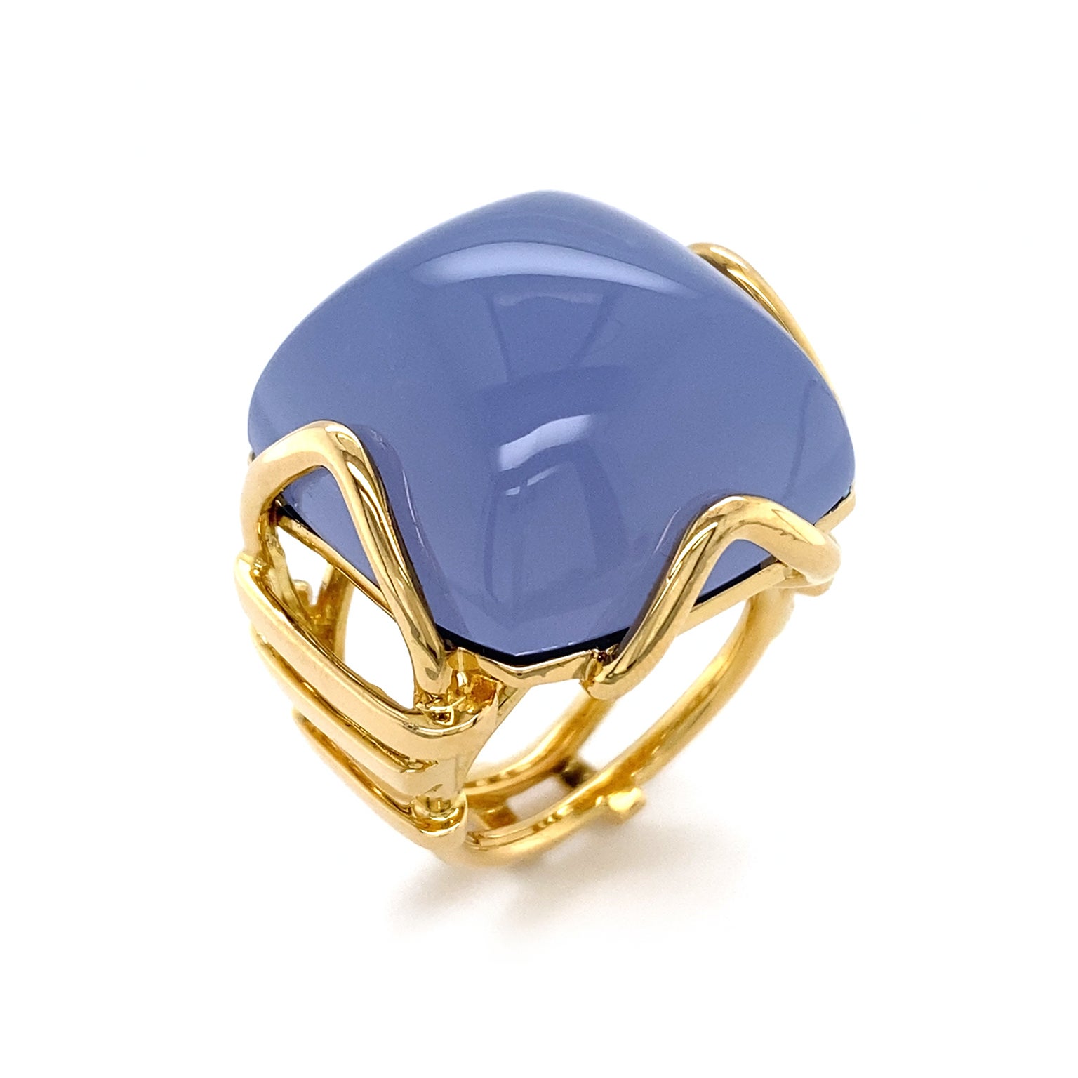 The deep lavender gray of chalcedony is displayed in this ring. 18k yellow gold triangular prongs secure a square cabochon of the gem. Slender strands of gold lay horizontal in a tapering pattern along the multi split band. The total weight of the