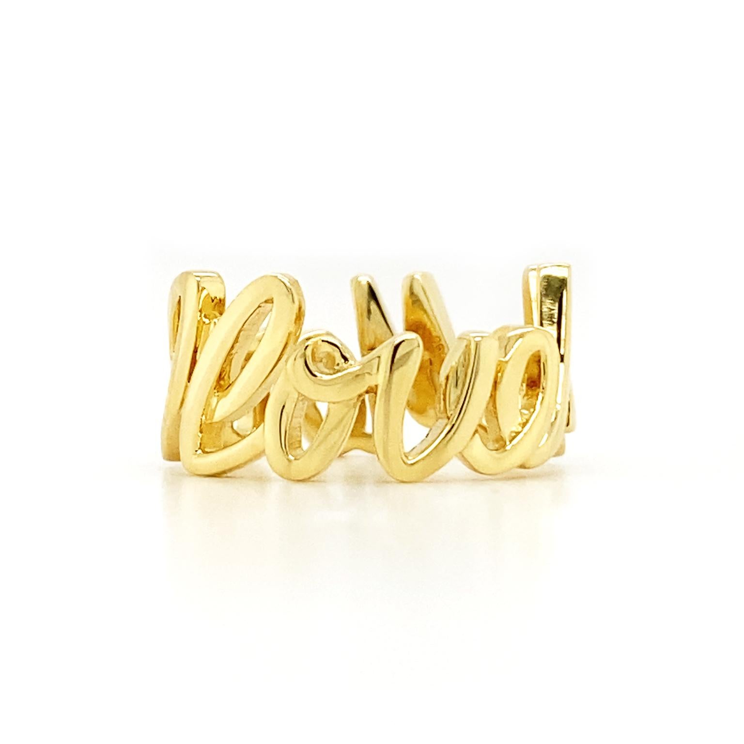 Gold replaces ink to make this ring. Rather than paper, 18k yellow gold is shaped into 9.75mm high letters, forming the message, 'I love me more.' The cursive font allows the letters to run together, turning the words into a band. A strong finish