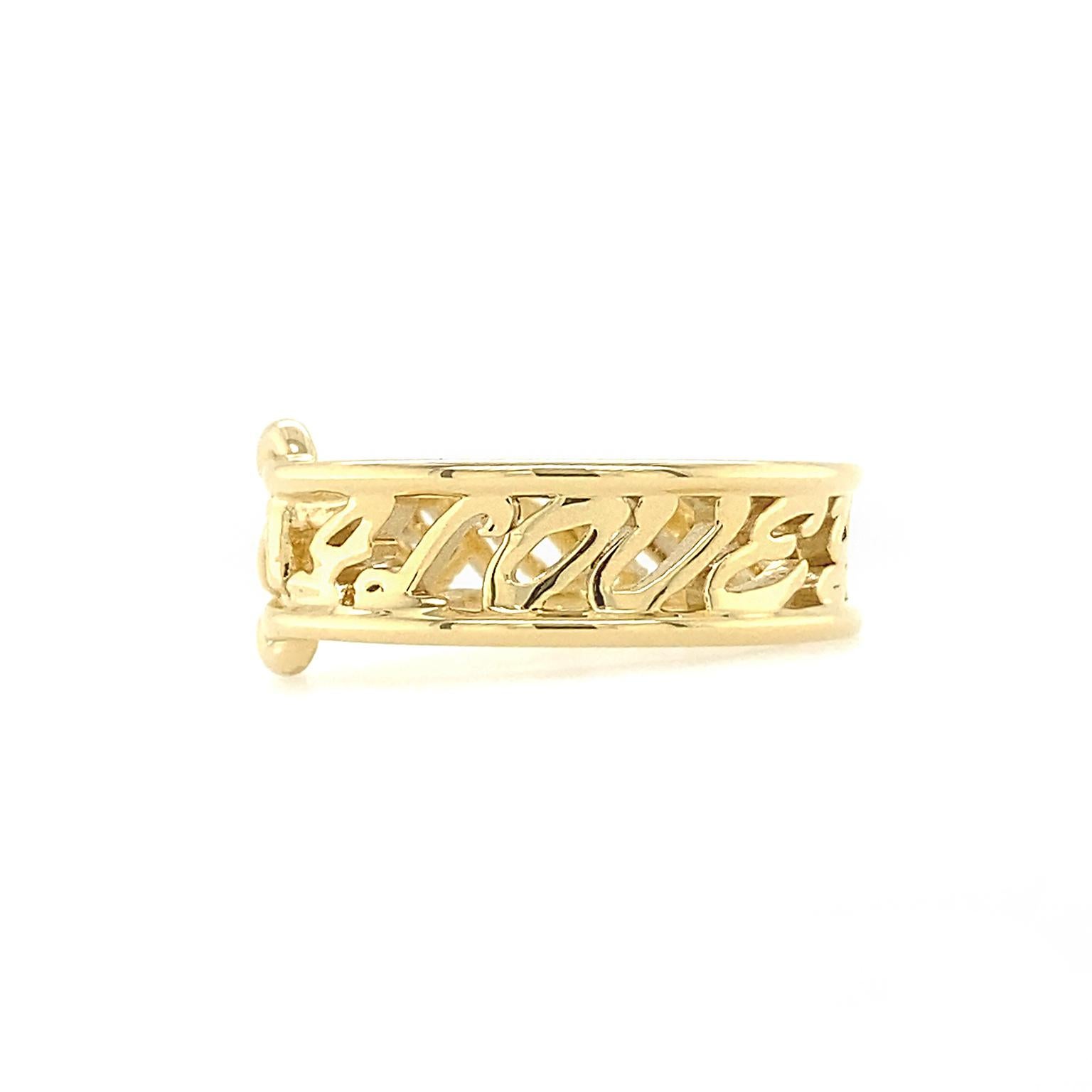 Scripted in 18k yellow gold reads the declaration I Love Me More. Slender bars frame the top and bottom of the 9mm tall letters, which wrap around the entire band. A woven knot at the top provides intrigue to the design while emphasizing the