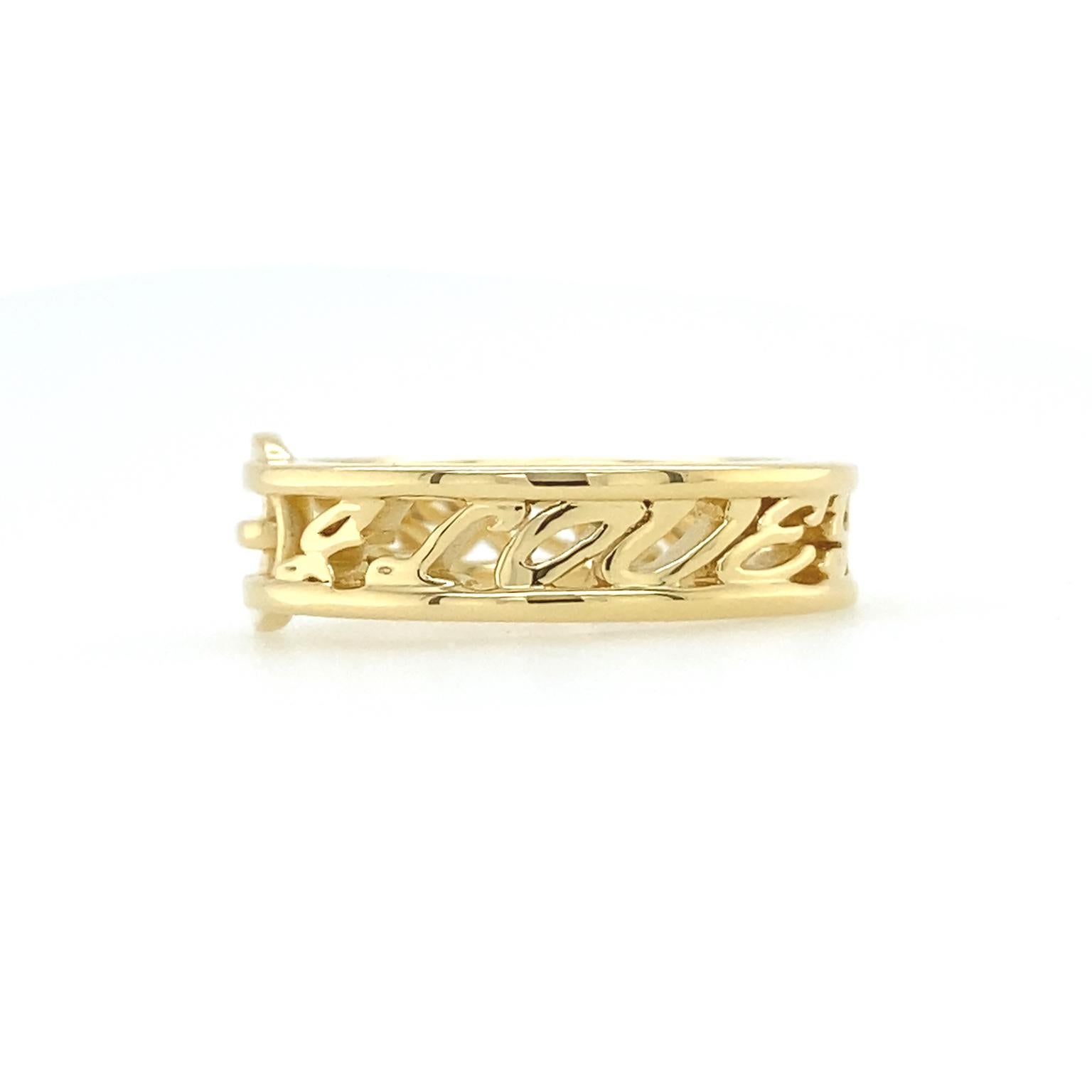 This ring showcases gold’s qualities. The precious metal is prized, among other things, for its color, luster and ease of shaping. Here, 18k yellow gold forms flat wires, framing the words 'I love you more' in 5mm high semi-cursive letters. A buckle