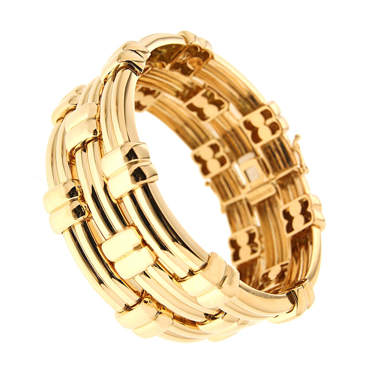 This triple line bracelet created by Valentin Magro, has a woven motif. Each of the three rows has an indent down the center, creating a ribbed look. Interspersed between them are shorter ribs which seem to bob in and out of the longer sections. A