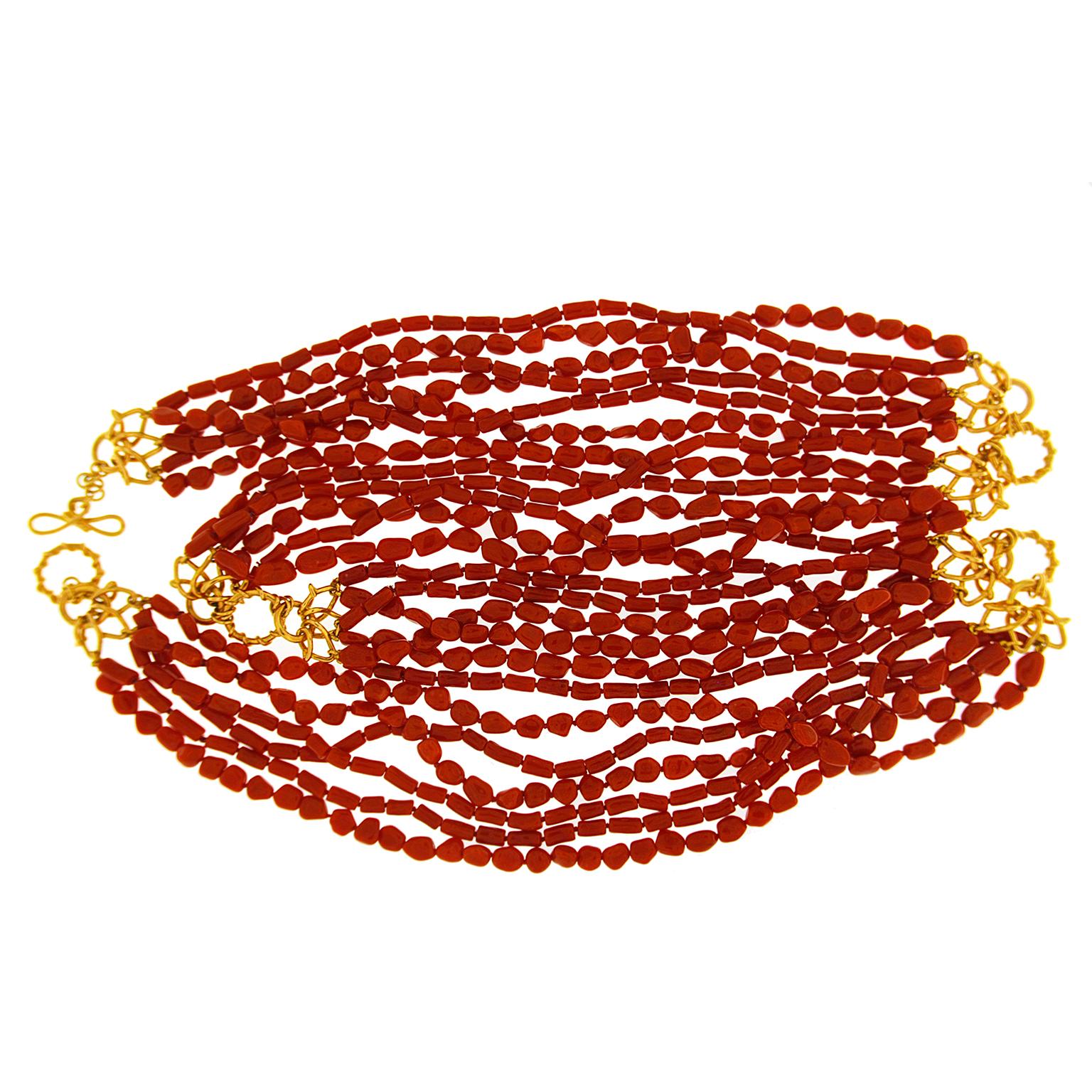 Valentin Magro Multi Strand Memmetti Coral Necklace boast warm hues. Recycled coral is cut memmeti style and placed on six twisted torsade strands. Altogether, there are 130.2 carats of coral. The sea of red is broken up with several 18k yellow gold
