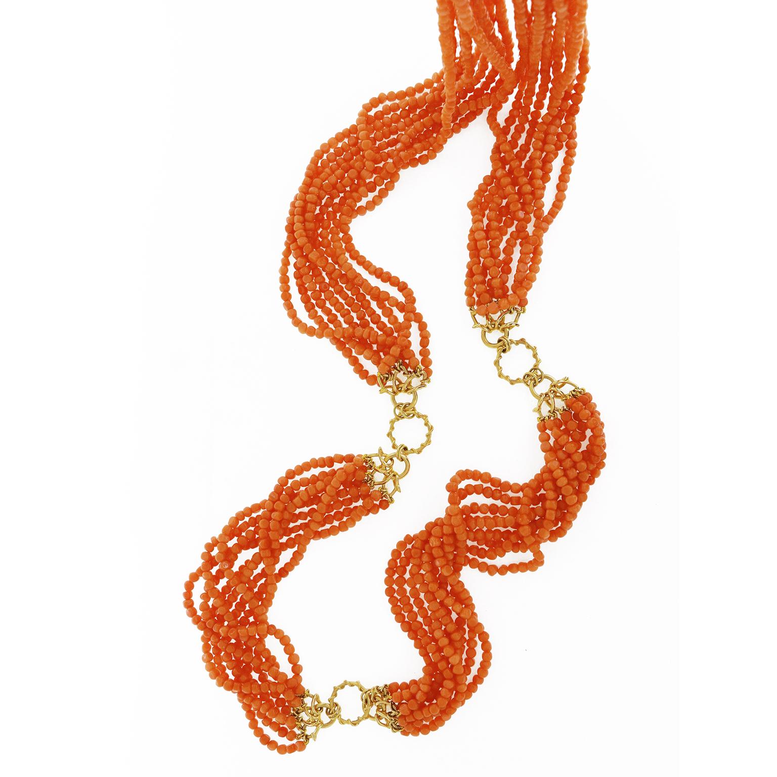 Valentin Magro Multi Strand Orange Pebble Coral Necklace is filled with a wealth of gems. The corals are carved into countless pebble-shaped beads. These are placed on a series of triple strands, including 10.5-inch, 11-inch, 7-inch and 11.5-inch