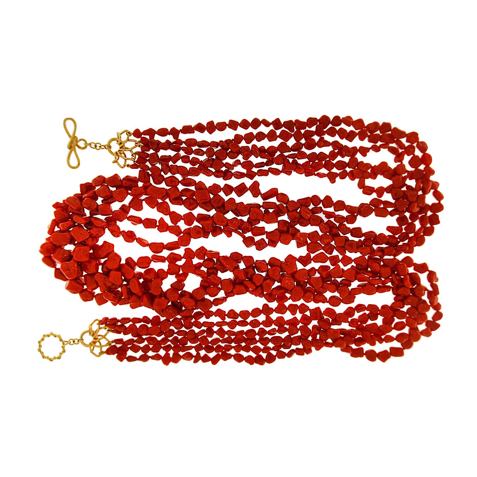 Valentin Magro Multi Strand Sardinian Red Coral Nugget Necklace boasts an abundance of jewels. Deep red Sardinian coral is carved into hundreds of beads. The nugget-shaped pieces range from miniscule at the ends to bold sizes in the center.