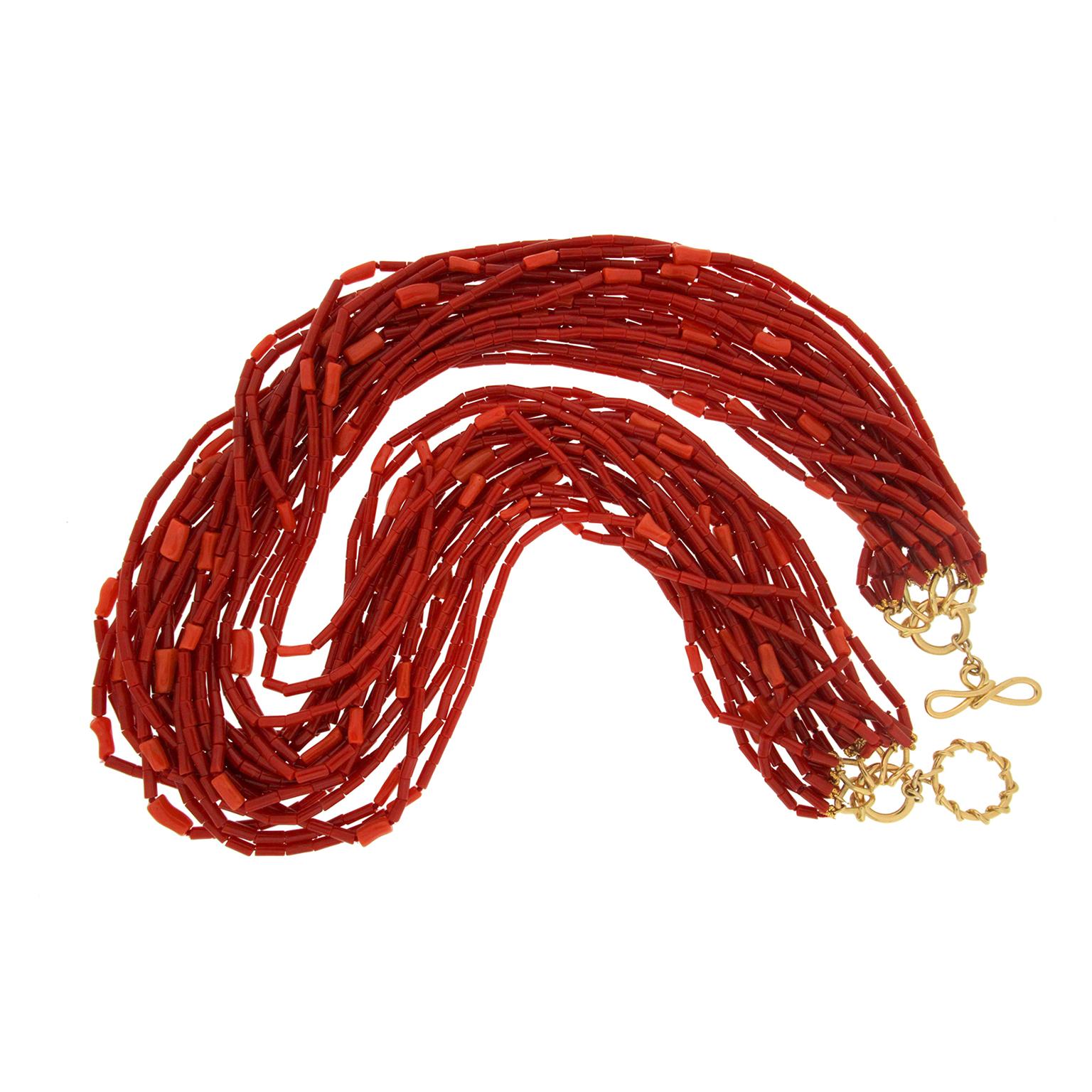 Valentin Magro Multi-Strand Tube Coral Torsade Necklace features subtle contrast. The body is made of dark red and orange coral, carved into countless tube beads. They are strung onto twenty-one strands and twisted into a torsade. Close inspection