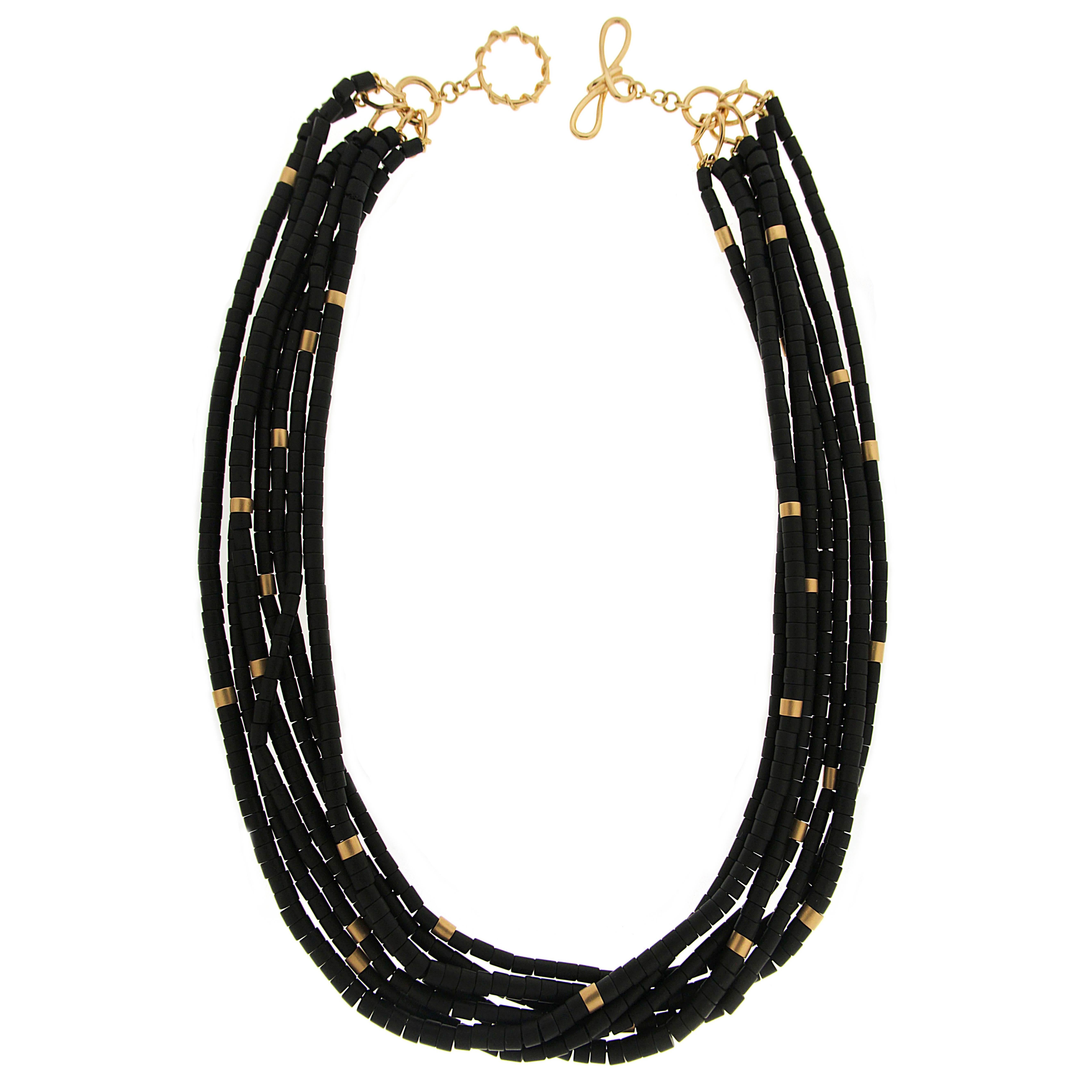 Valentin Magro Onyx Gold Tube Necklace features bright accents. The jewel of choice is onyx, carved into tubes. They are placed onto six strands, with the occasional 18k yellow gold bead for a burst of color. Every bead reflects a matte polish.