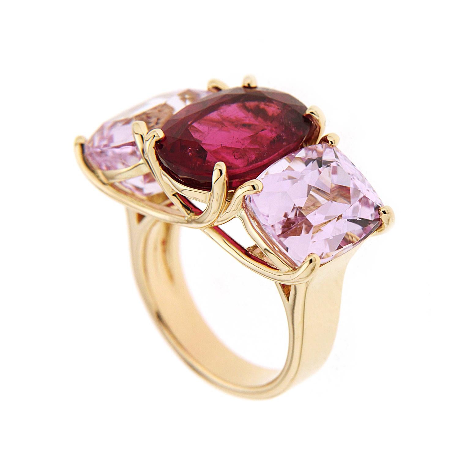 Valentin Magro Oval Rubellite and Kunzite Ring is made of rosy hues. The central jewel is dark rubellite tourmaline shaped into an oval. On either side are cushion shaped kunzites with checkerboard facets. The gemstones rest within 18k yellow gold