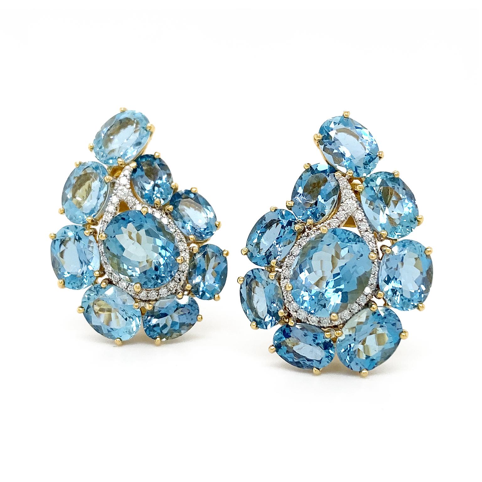 The retro ornamental design of paisley is given an elegant rendition in these earrings. Aquamarine in oval shapes outline the curved teardrop pattern, with a larger oval of the gem in the center. In between these two gems are brilliant cut diamonds