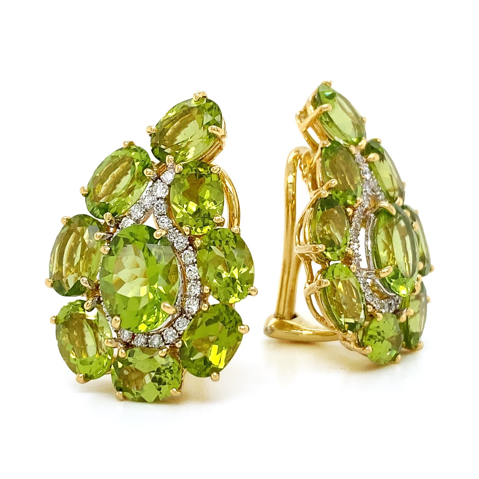 Scintillating yellow green peridots refreshen the classic paisley design. Oval shaped cuts of the jewel form the outline of the curved teardrop shape, while a strand of brilliant cut diamonds borders within to emphasize the pattern. In the center is