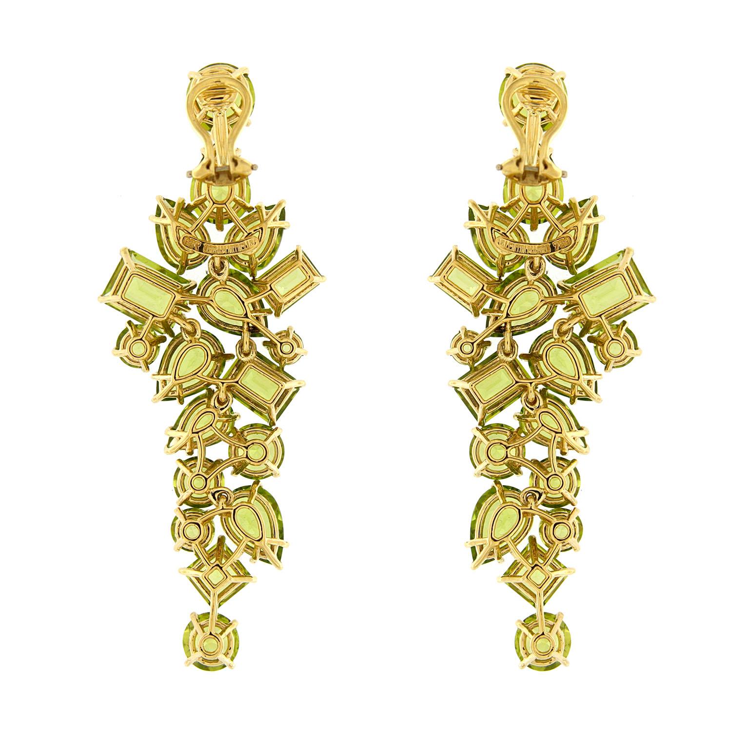 A torrent of light and warmth is created from these peridot drop earrings. The design begins and ends with a single round peridot. In between is a sparkling assortment of pear, emerald, square and round shaped cuts of the gem for a widening