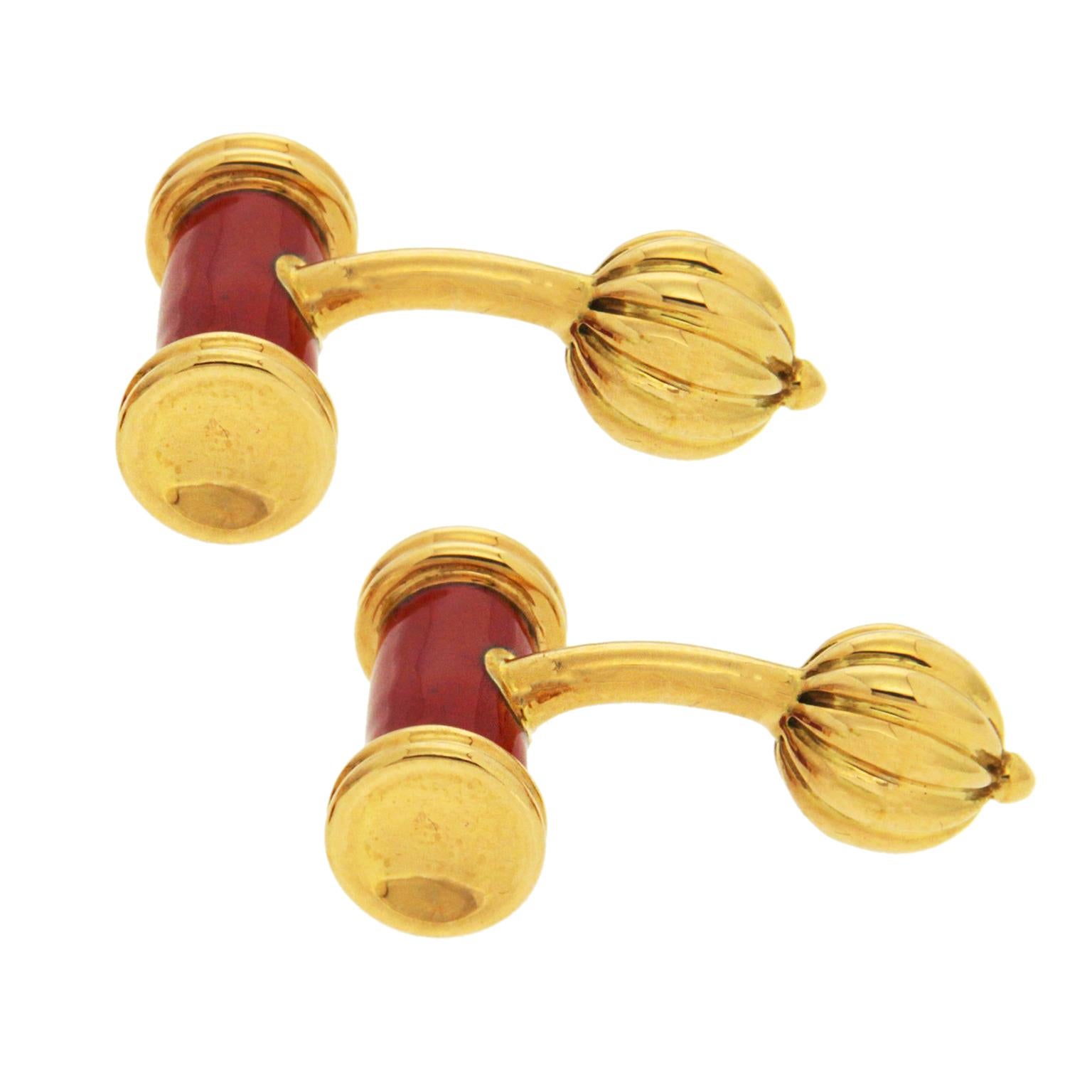 Warm colors make up these cufflinks. The fronts are bars with 18k yellow gold ends and a deep red enamel center. The reverse sides feature posts tipped with fluted balls. Each cufflink measures 0.35 inches wide, 0.71 inches long and 1.05 inches tall