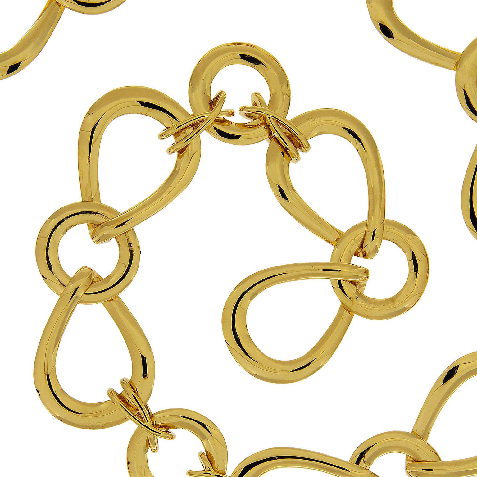 Complementing 18k yellow-gold outlines of circles and pears interlinked together by slender interlaces. Collectively the round shapes between two pears give the illusion of bows throughout the design of this necklace. A knot and toggle clasp closes