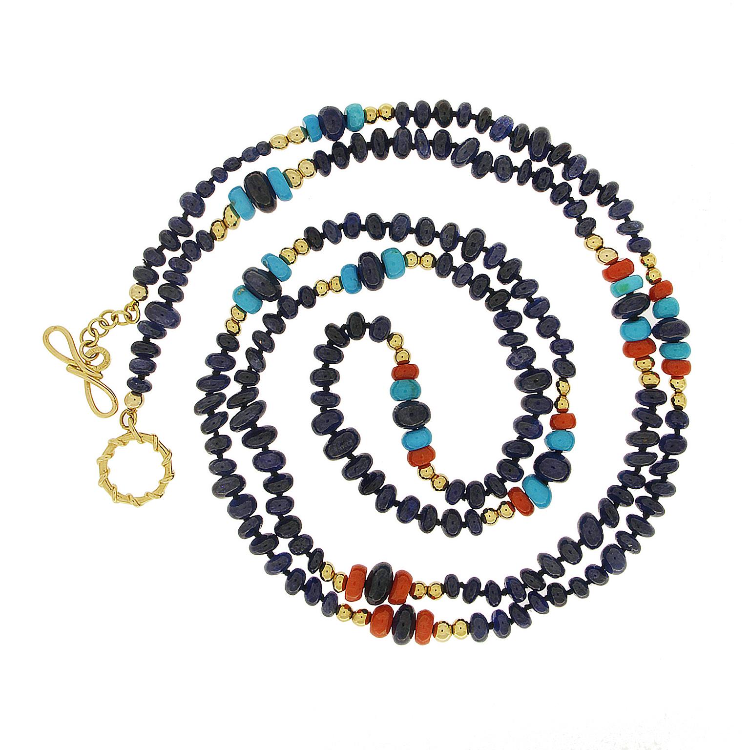 A vivid array of gems circulate throughout this necklace. Sapphires are the focus with additional beads of red coral and Sleeping Beauty turquoise as complements. 18k yellow gold beads combine with the gemstones in different designs for captivating