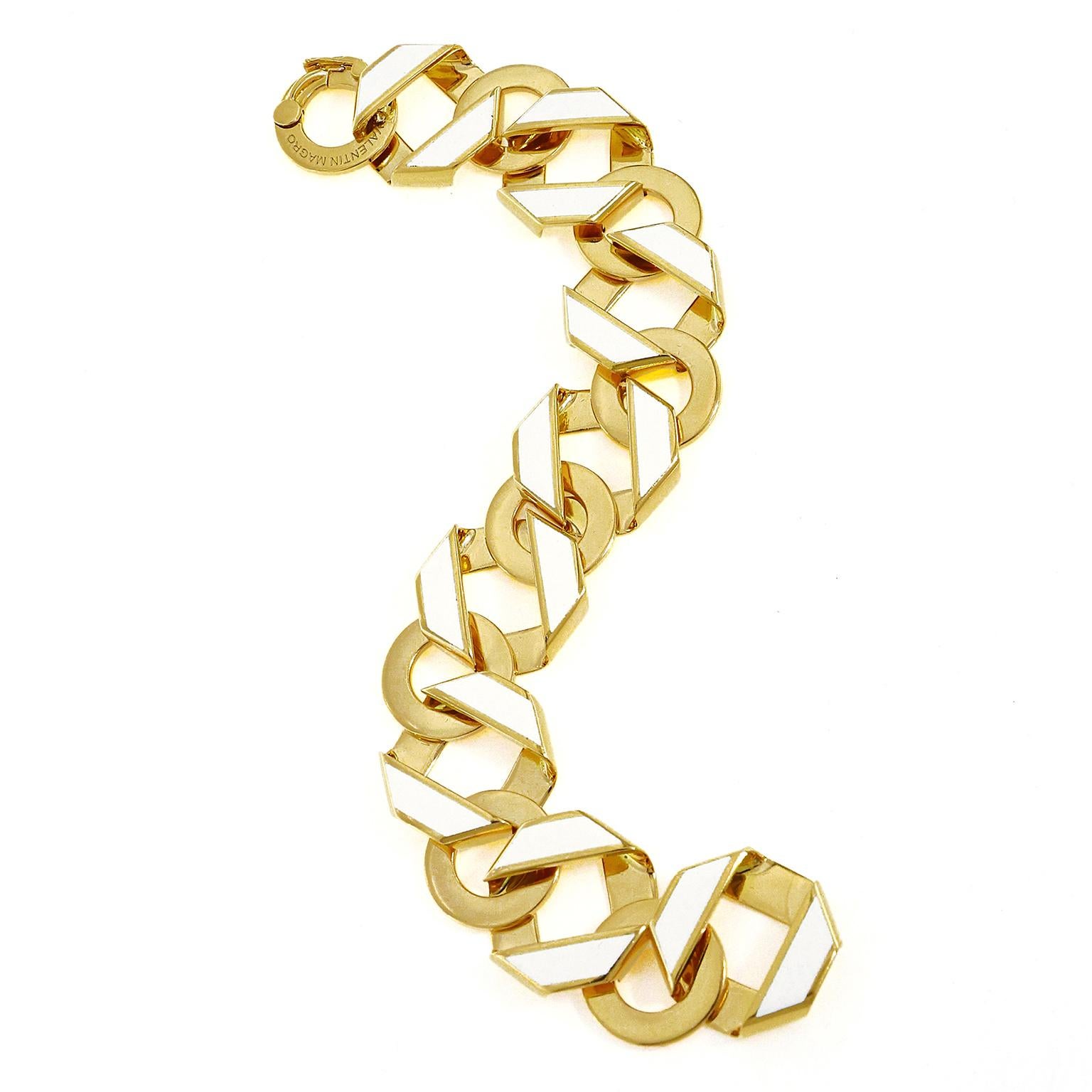 18k yellow gold and white enamel join together to bring a glow for this bracelet. An intertwined pattern of flattened hexagonal strips alternate with flat discs. The hexagonal strips feature white enamel on the sides for the gold to reflect in order