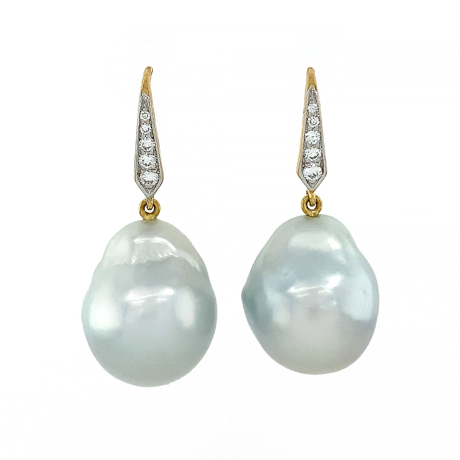 Lustrous elegance is emitted by these earrings. 18k yellow gold lever backs with pave set brilliant cut diamonds produce glittering light. Descending from this is a single south sea pearl, where its baroque shaped body creates iridescent allure that