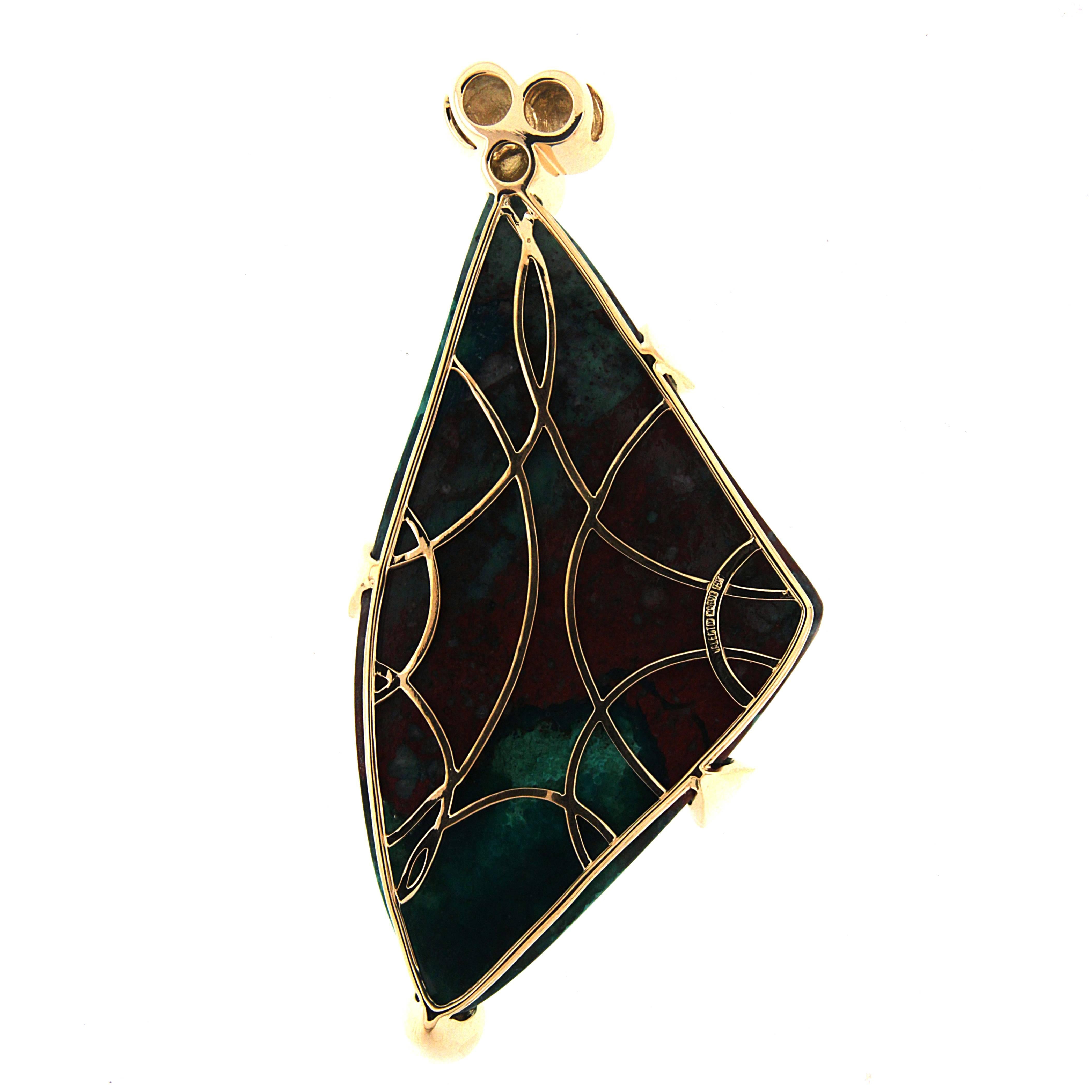 Vibrant blues of azurite and varied greens of malachite merge for this pendant. A half-moon cut of the gemstone features round green shapes throughout. 18k yellow gold sets the charm, with round-edged prongs wrapped around the edges. Brilliant cut