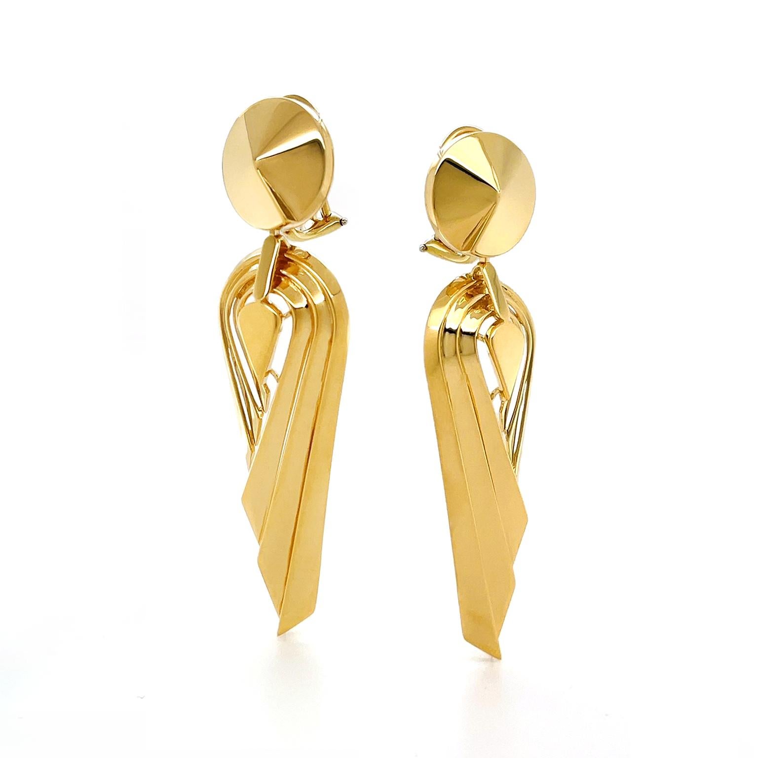 Influenced by the monochromatic styles and angles of Art Deco, the design of these drop earrings gives a modern update. Beginning with an 18k yellow gold raised pointed base, follows three grooved strips that form an upturned asymmetrical teardrop.