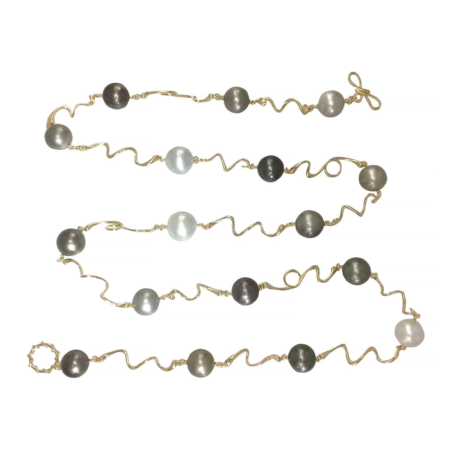 Valentin Magro Tahitian Pearl Beads Wave Necklace is embellished with gradations. The jewels of choice range from white South Sea pearls, black Tahitian pearls and shades of grey in between. Wavy 18k yellow gold links the gems while serving as a