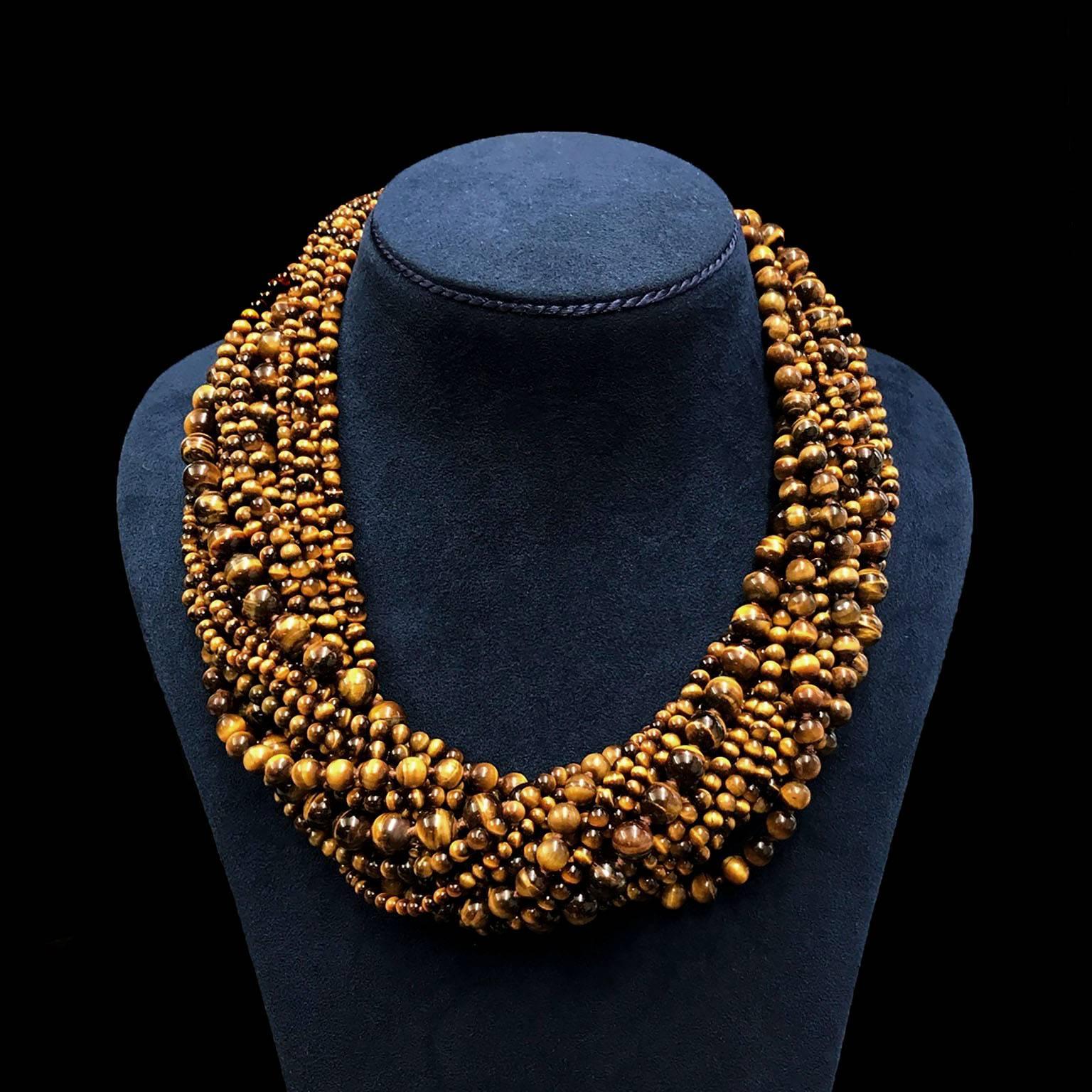 Valentin Magro Tiger's Eye Bead Multi Strand Necklace with Gold Clasp abounds with phenomenal jewels. The gem of choice is tiger’s eye quartz, famed for its chatoyant stripes. They’re carved into beads of various diameters before they’re strung with