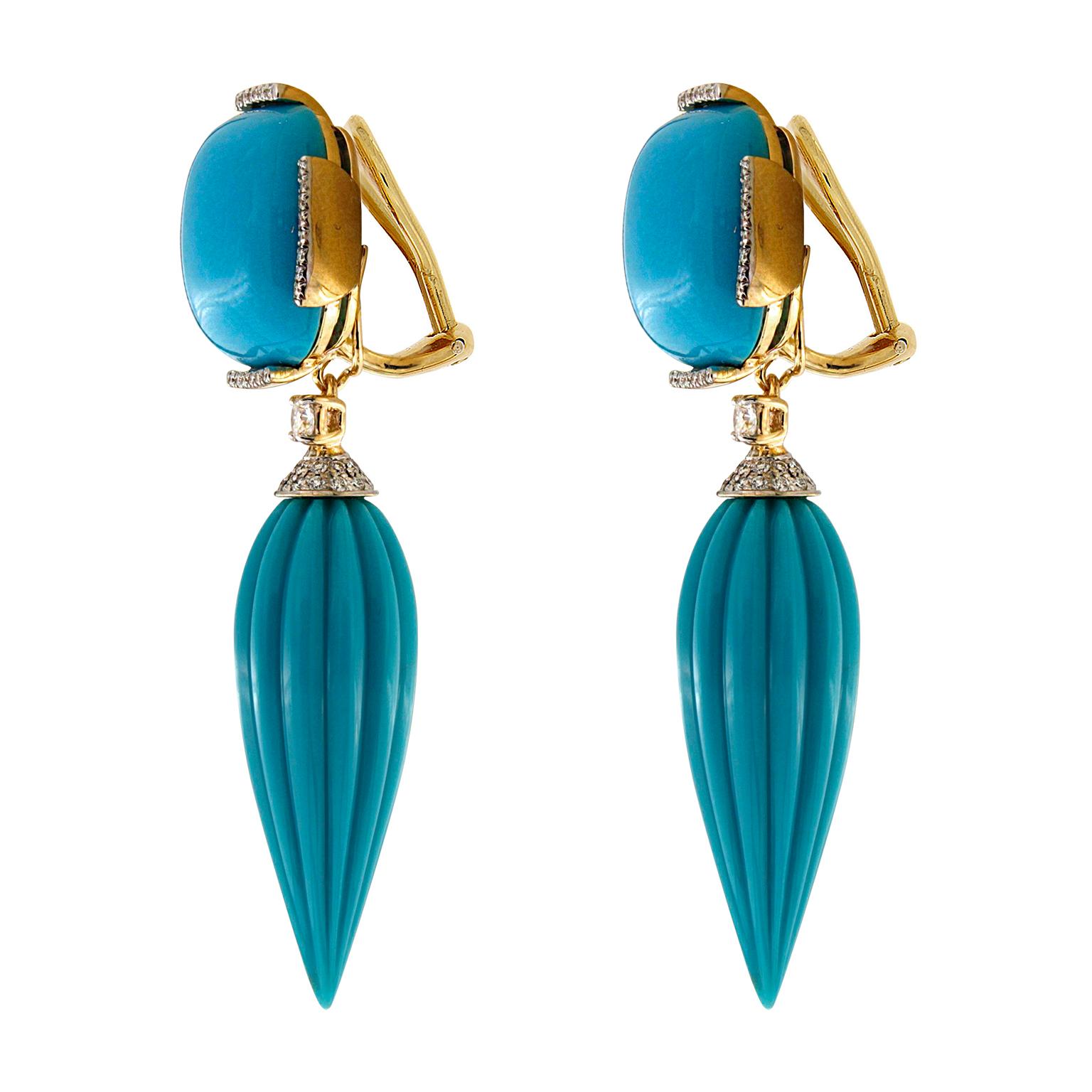 Blue and white enliven these drop earrings. Their foundation is 18k yellow gold, which displays a cushion shaped turquoise cabochon at the top. Bars studded with round brilliant cut diamonds edge the blue gemstone. Underneath hangs a fluted