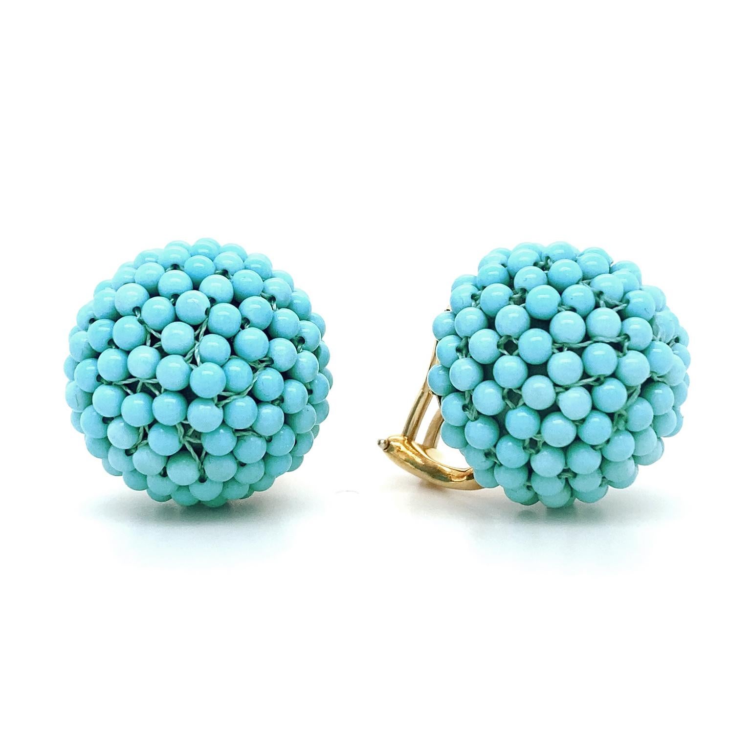 Intense sky-blue hues of turquoise are acclaimed in these earrings. Carved into small round beads, the gems are carefully strung densely together on a 23mm orb for a cohesive arrangement. 18k yellow gold clip-backs finish the earrings, which measure
